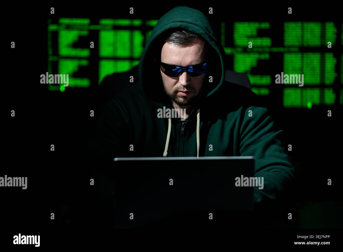 Hacker works on programming and coding. Hacker analyzes digital system vulnerabilities. Hacker monitors secure network infrastructure. Hacker attempts Stock Photo