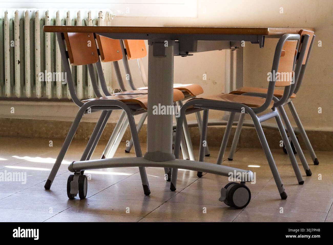School Table And Chairs In Empty Classroom Stock Photo