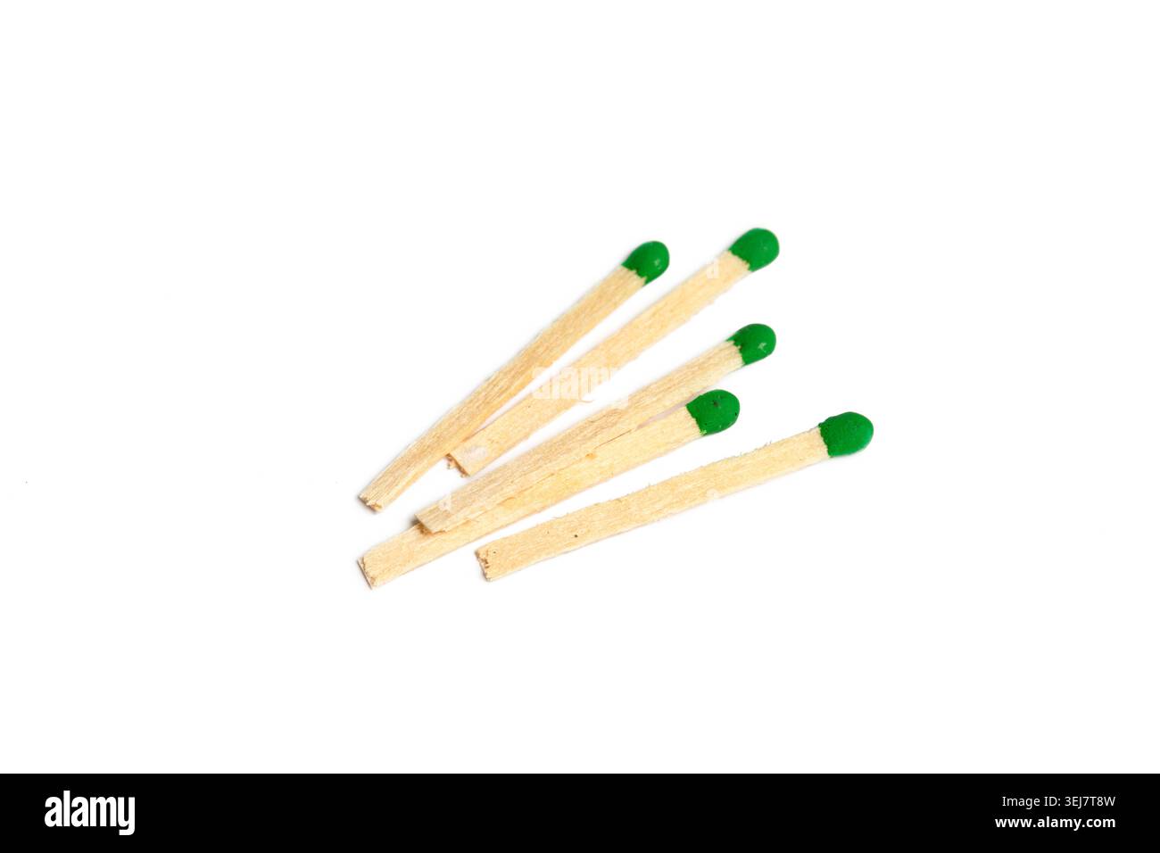 Several matchsticks with green tips on a white background placed flat Stock Photo