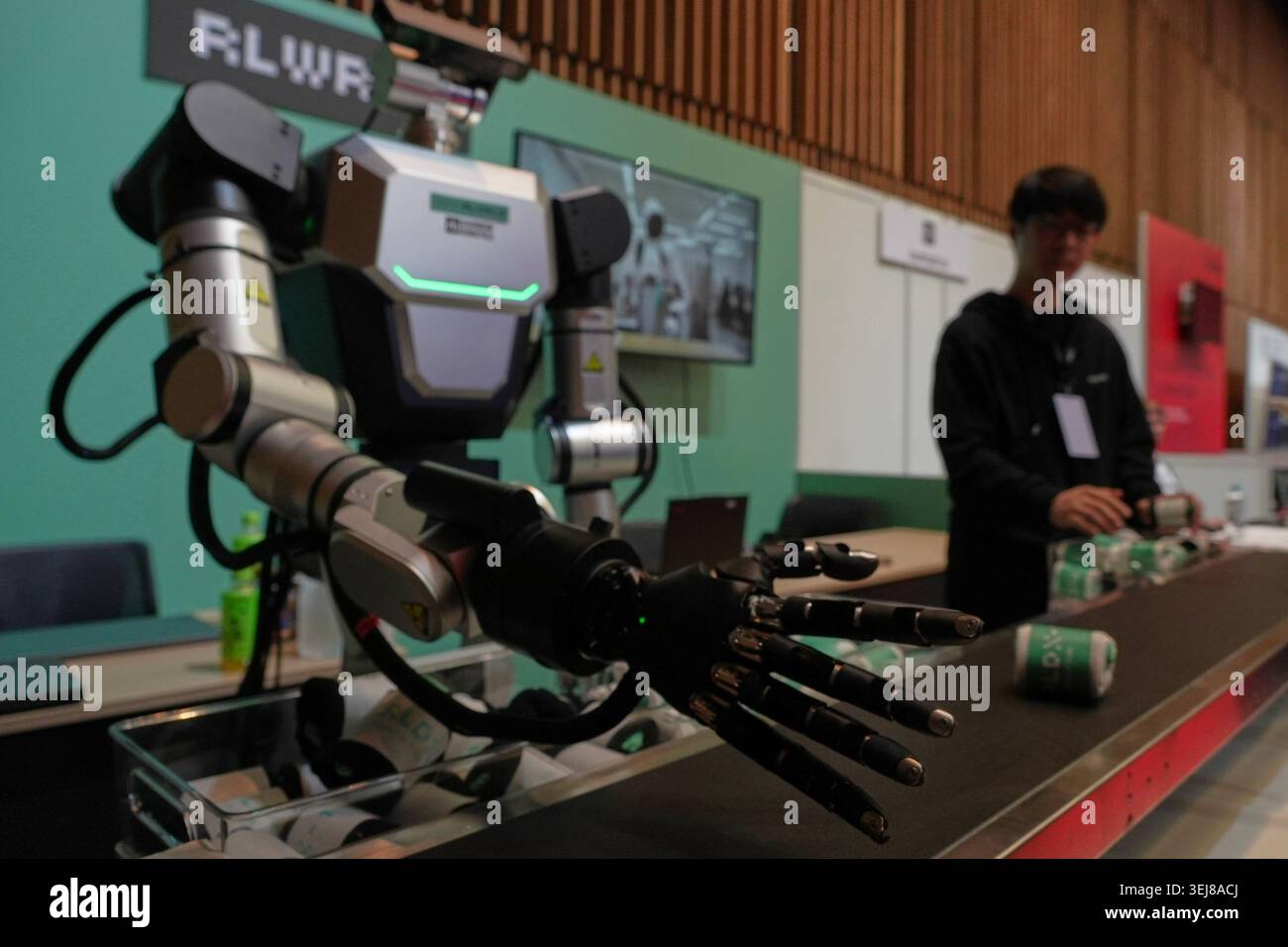 A robot demonstrates picking up a pair of socks at the Humanoids Summit ...