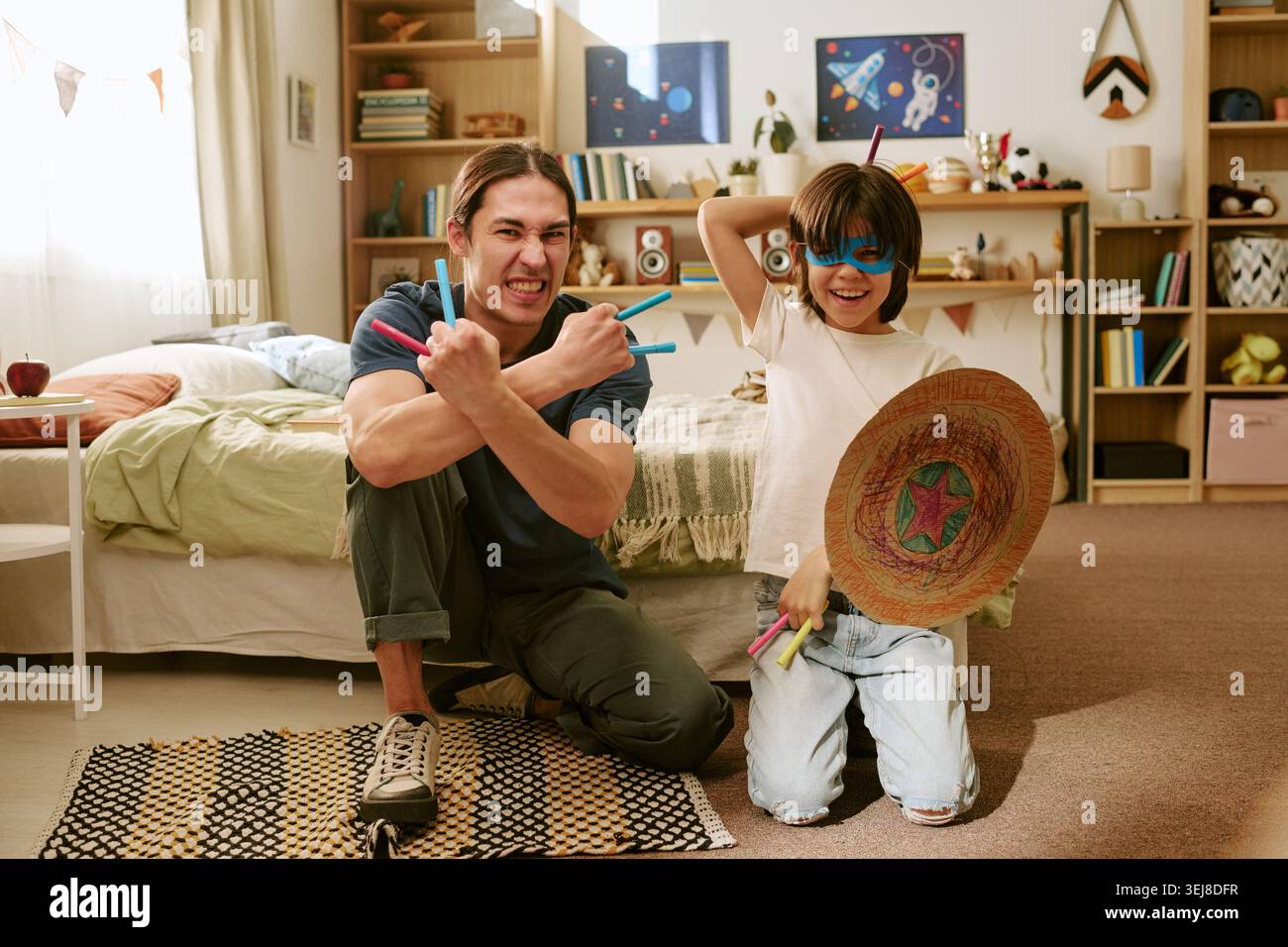 Father and Son Playing Superhero Game for Family Bonding Stock Photo