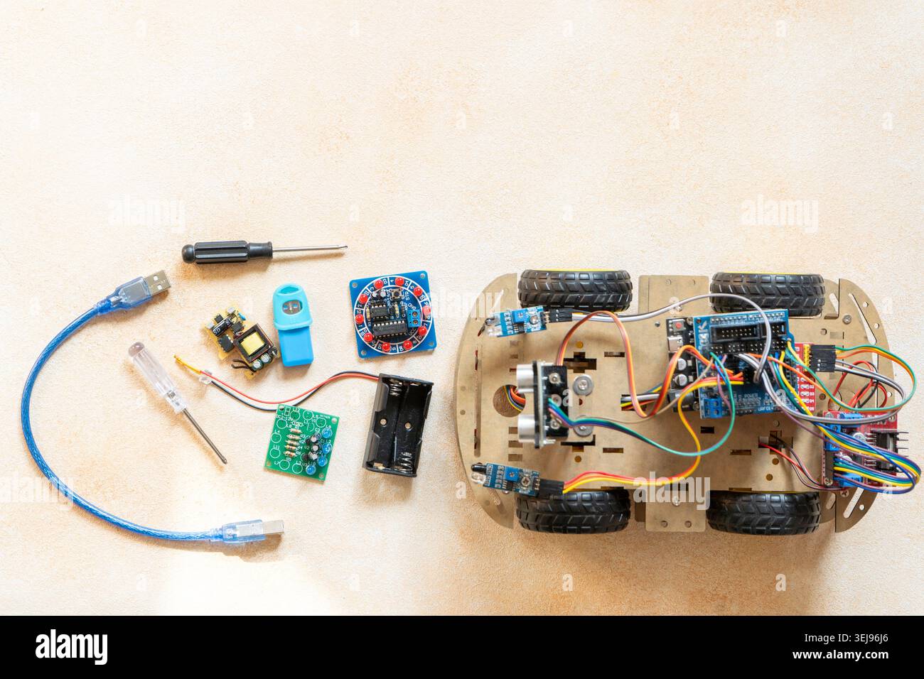 DIY Robot Car Assembly and Components top view. Educational electronics project for STEM learning and robotics. Stock Photo
