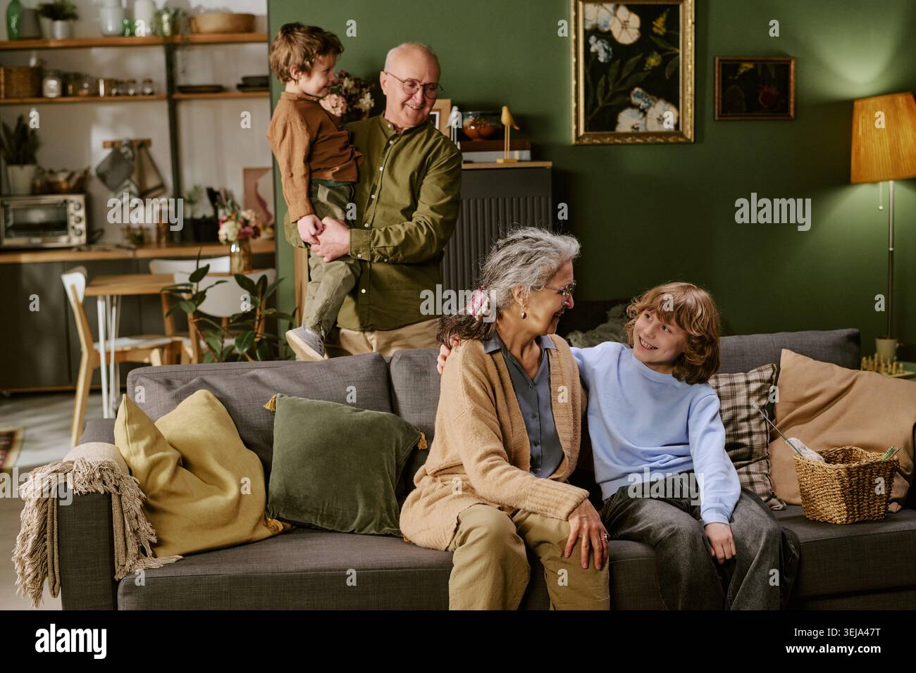 Senior Couple with Grandchildren Spending Time at Home Stock Photo