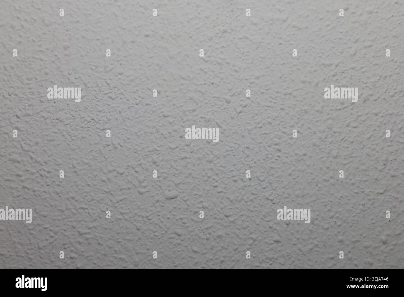 White textured stucco wall surface background creating pattern Stock Photo
