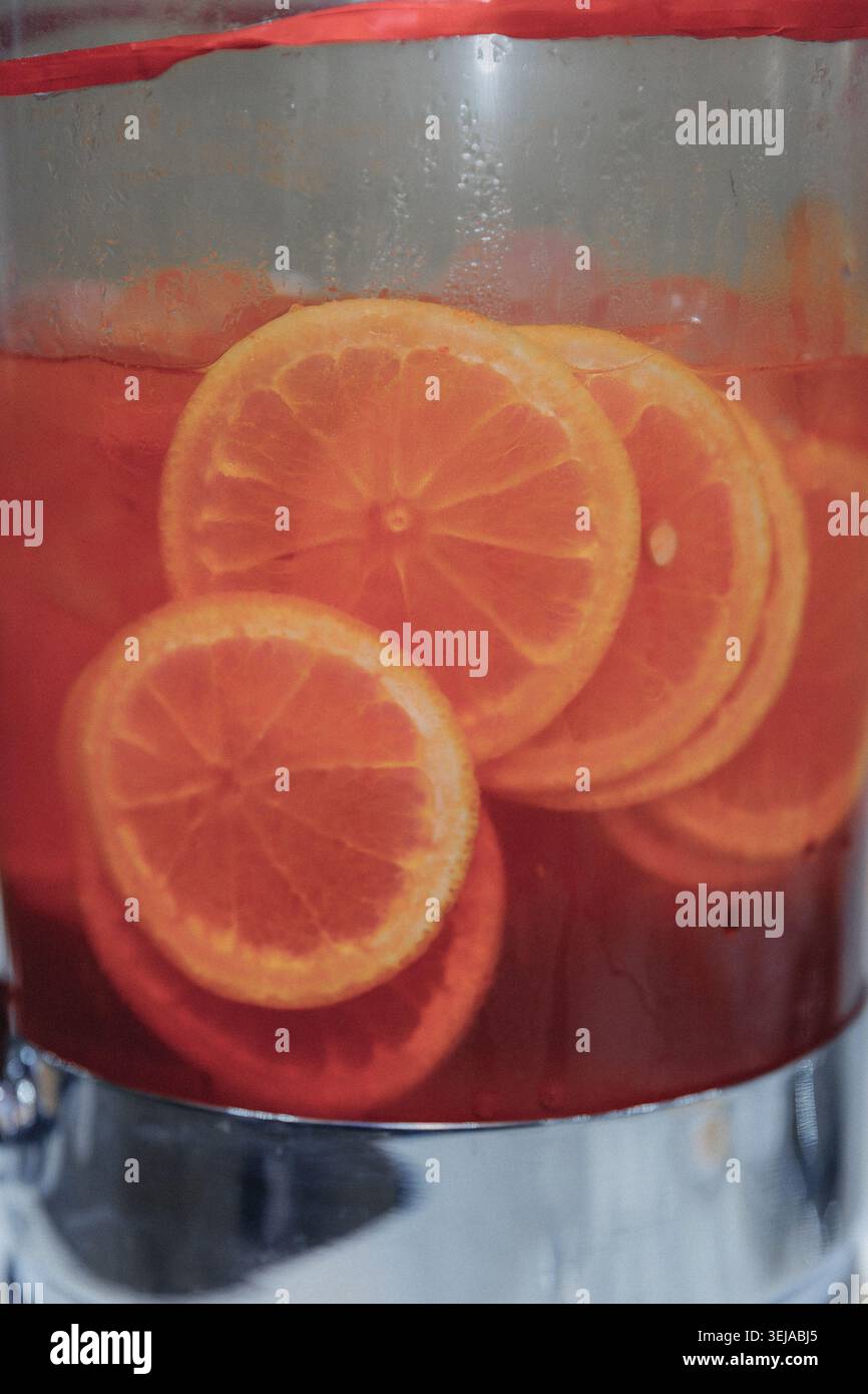 Vibrant orange slices float in rich red liquid Stock Photo