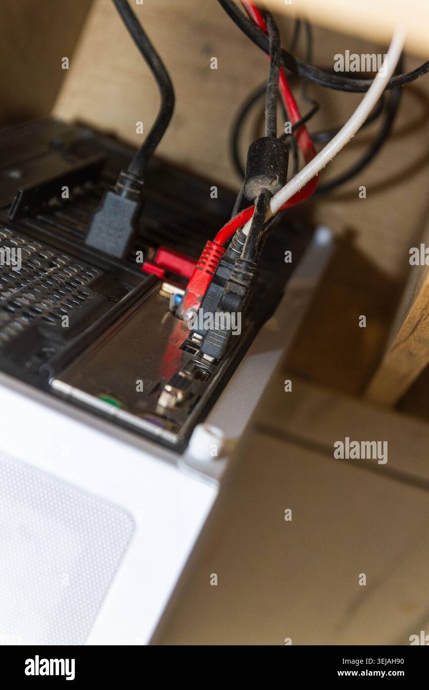 Messy Computer Cables and Internet Network Wires Connected to PC Back Panel Stock Photo