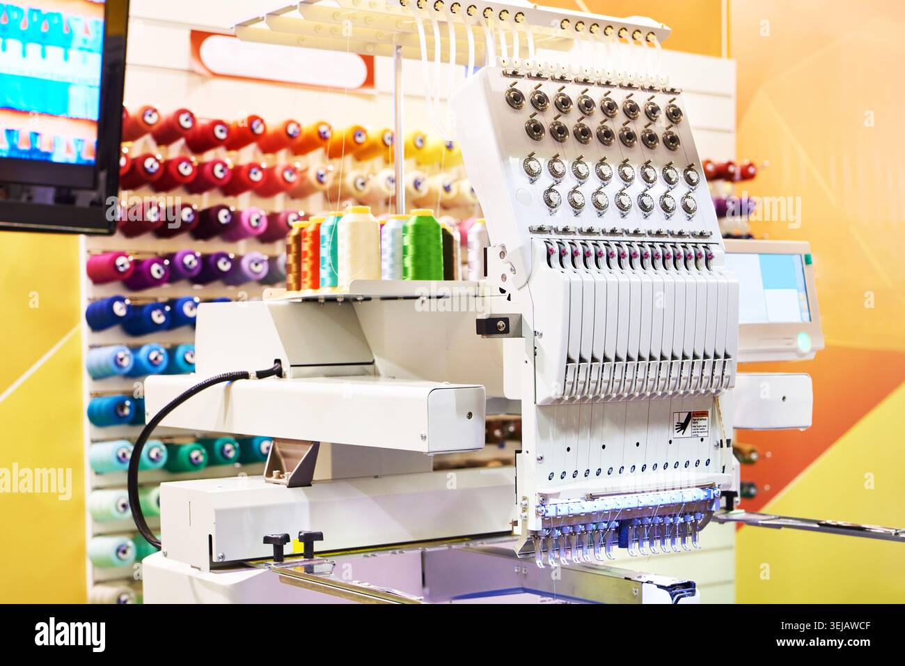 Embroidery industrial machine in sewing workshop Stock Photo