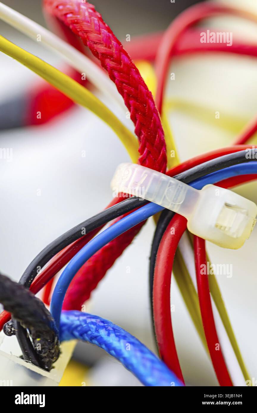 Multicolored electrical cables isolated close up. Vertical image. Selective focus Stock Photo