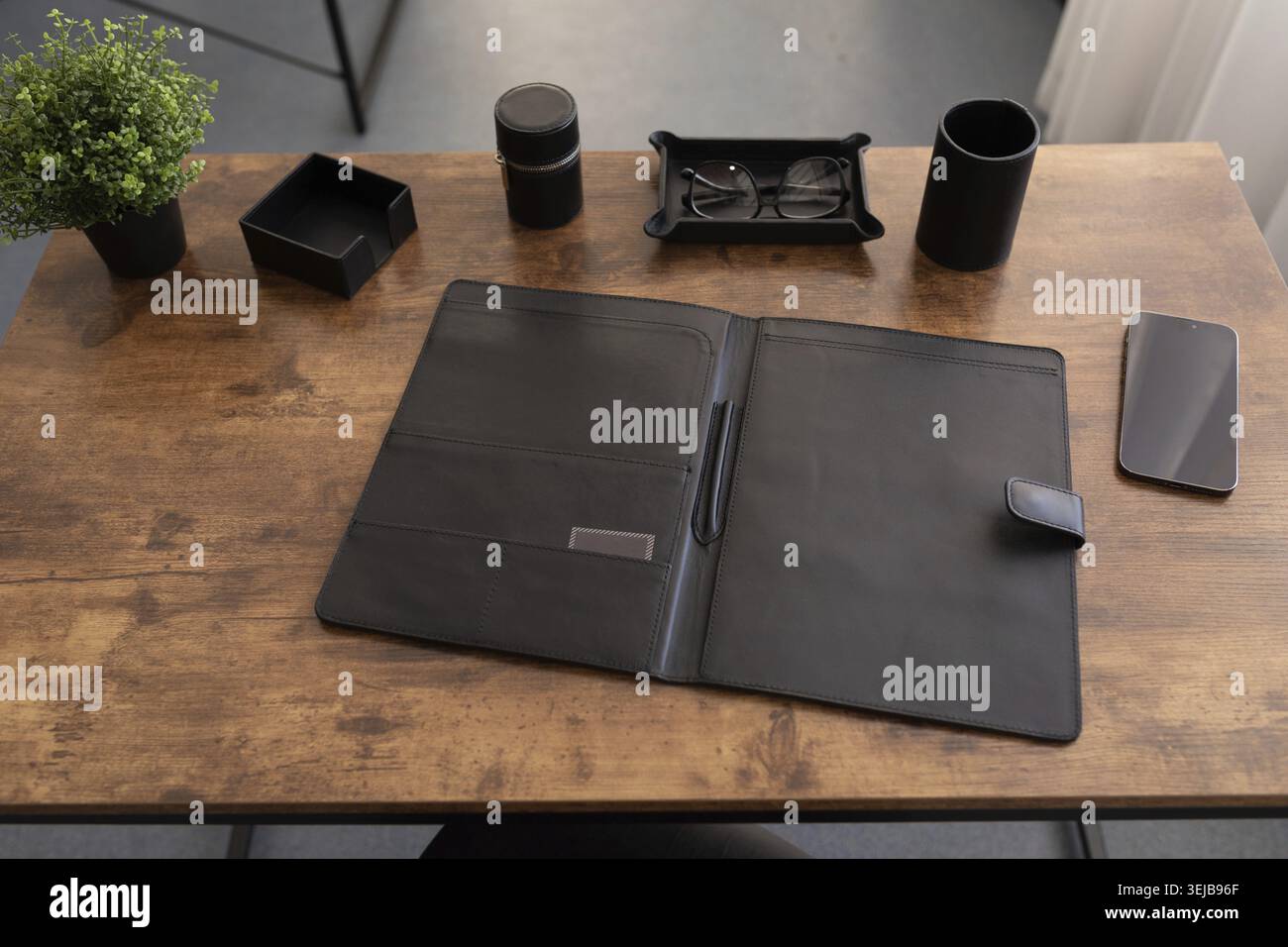 Office desk with stationery leather folder for papers and documents Stock Photo