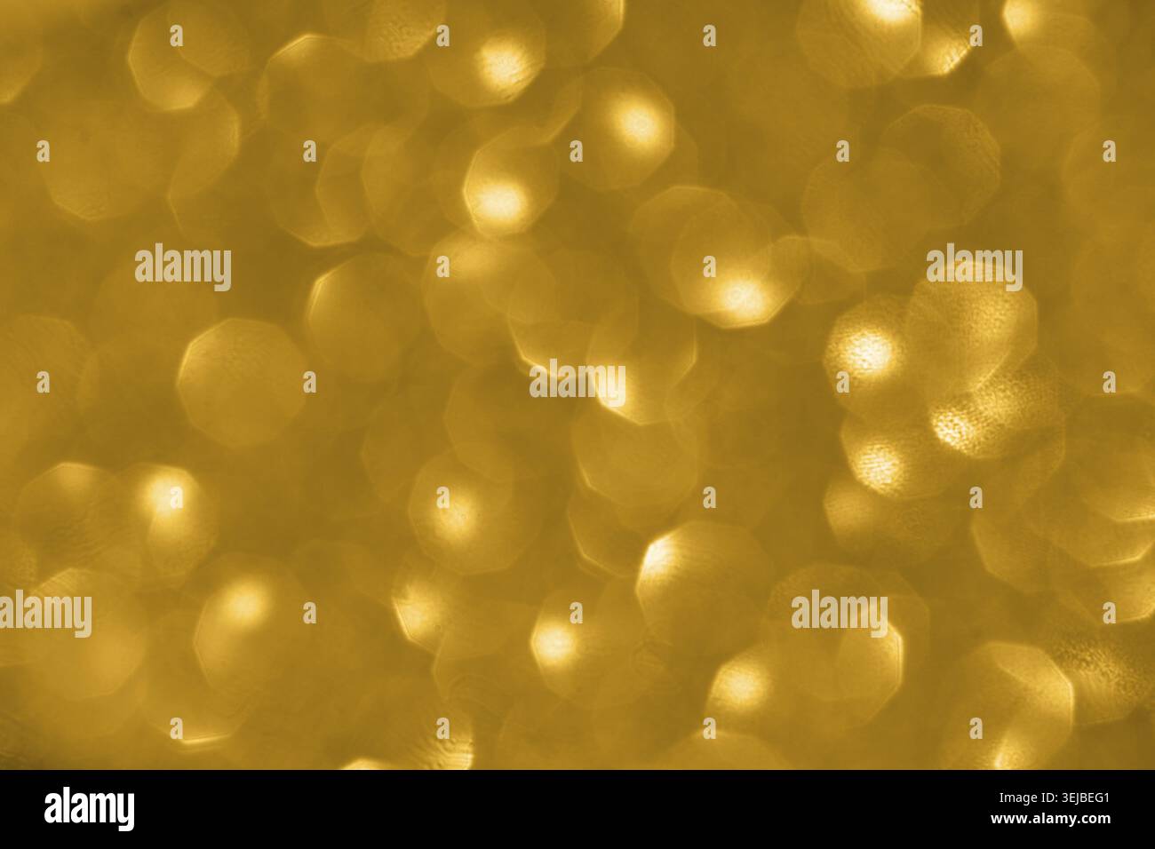 Golden bokeh background with soft circular light patterns creating a warm, glowing abstract effect Stock Photo