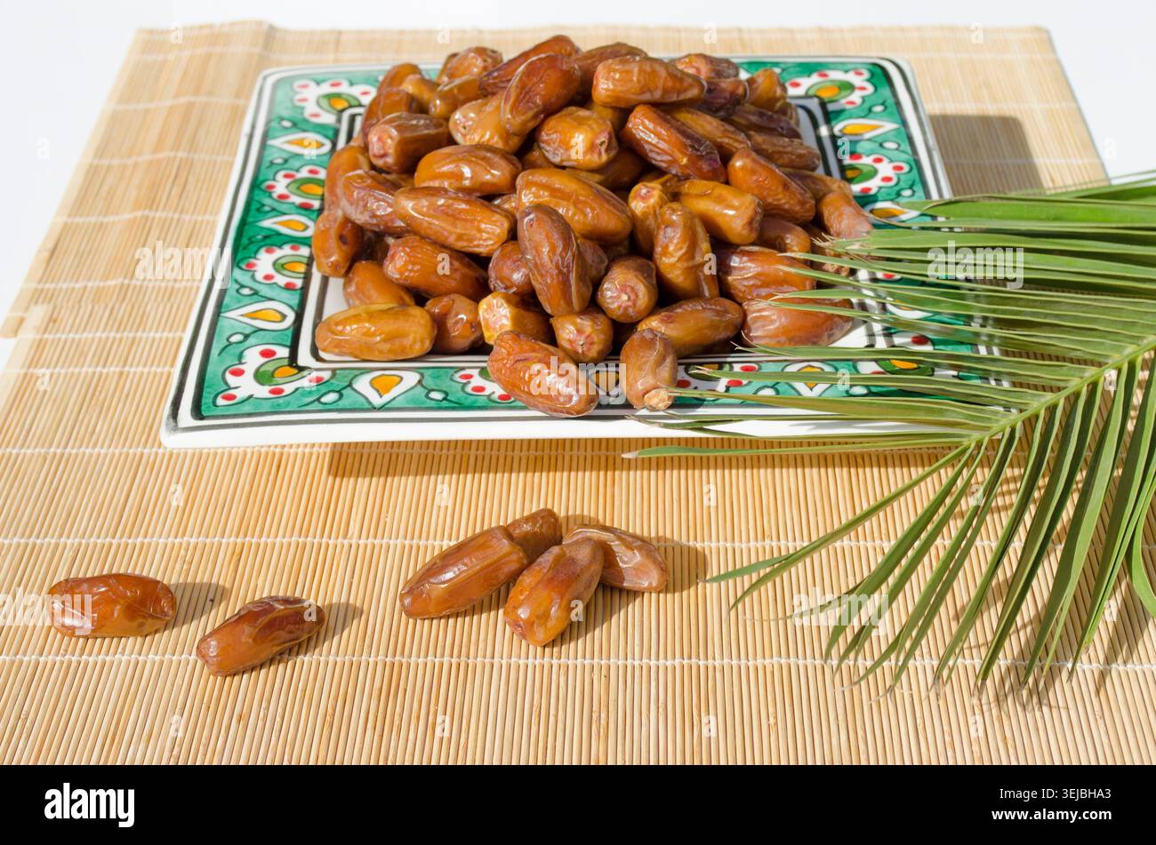 Ripe organic dates served on decorative ceramic plate. Stock Photo
