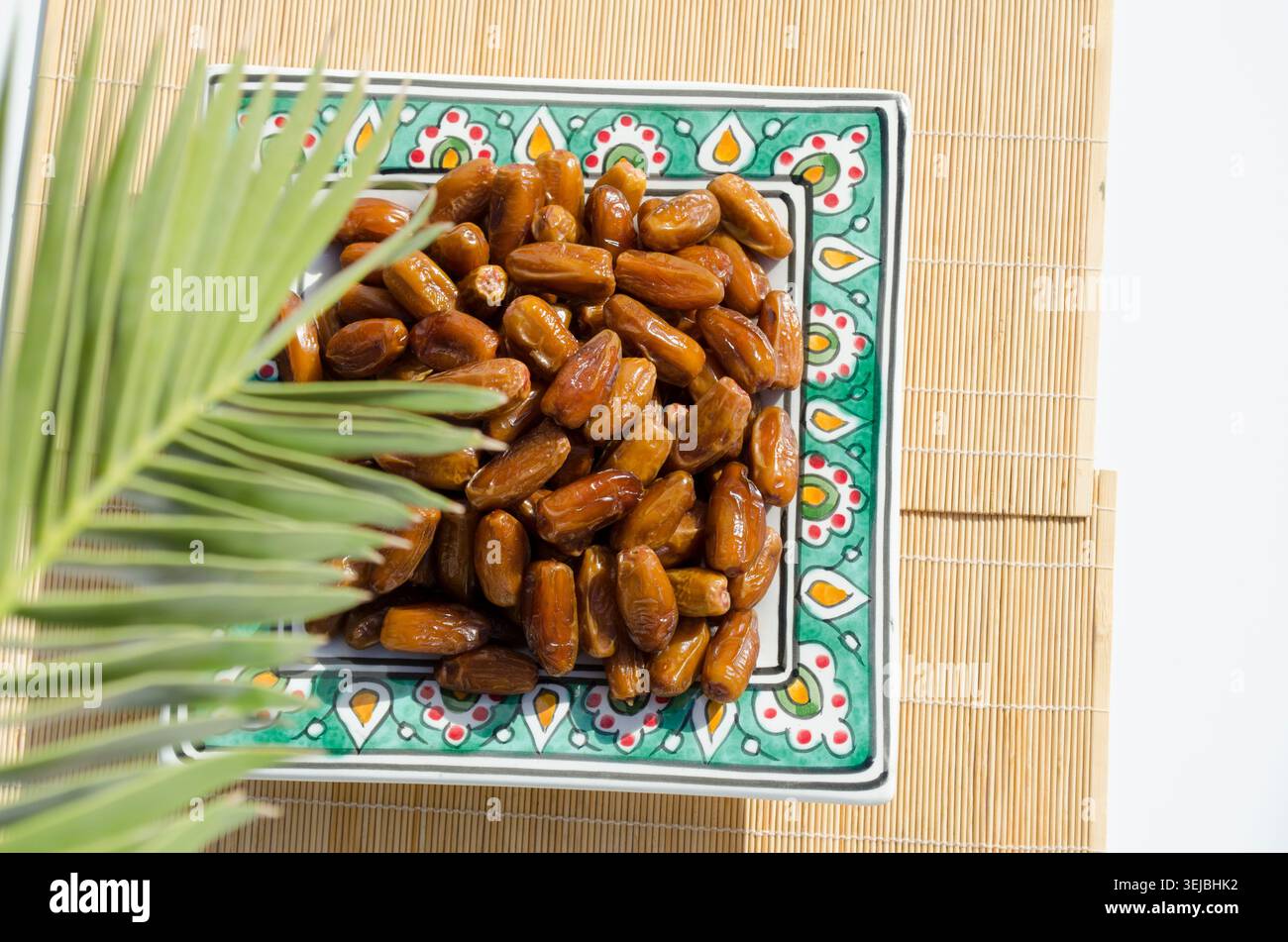 Ripe organic dates served on decorative ceramic plate. Stock Photo