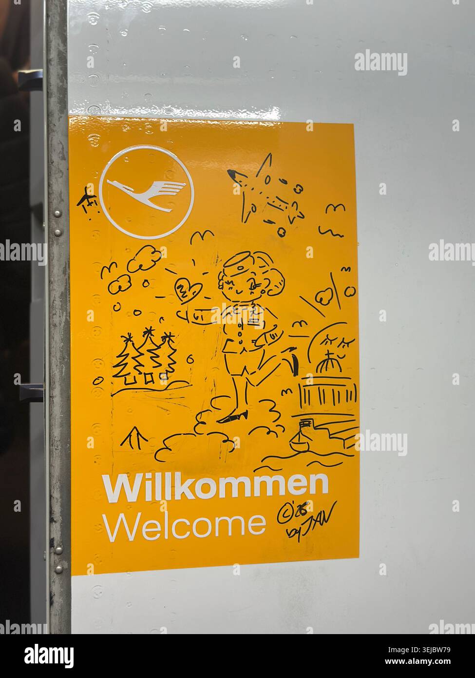 Welcome drawing next to main entrance door of Lufthansa plane - Smartphone Captured Stock Image