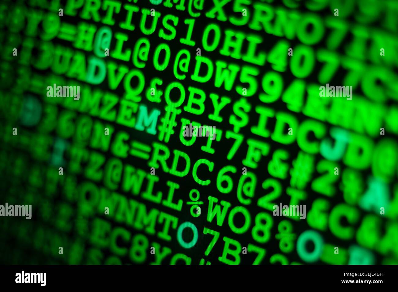 Glowing green computer code and hexadecimal numbers displayed on a dark screen with shallow depth of field Stock Photo