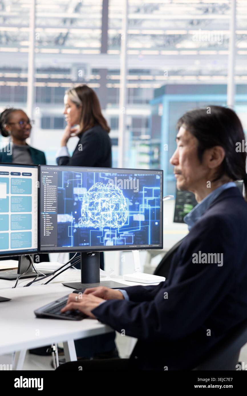 Training AI model, RD and Asian man in microchip factory RD office optimizing hardware. Using artificial intelligence, improving manufacturing efficiency and senior programmer in research lab Stock Photo