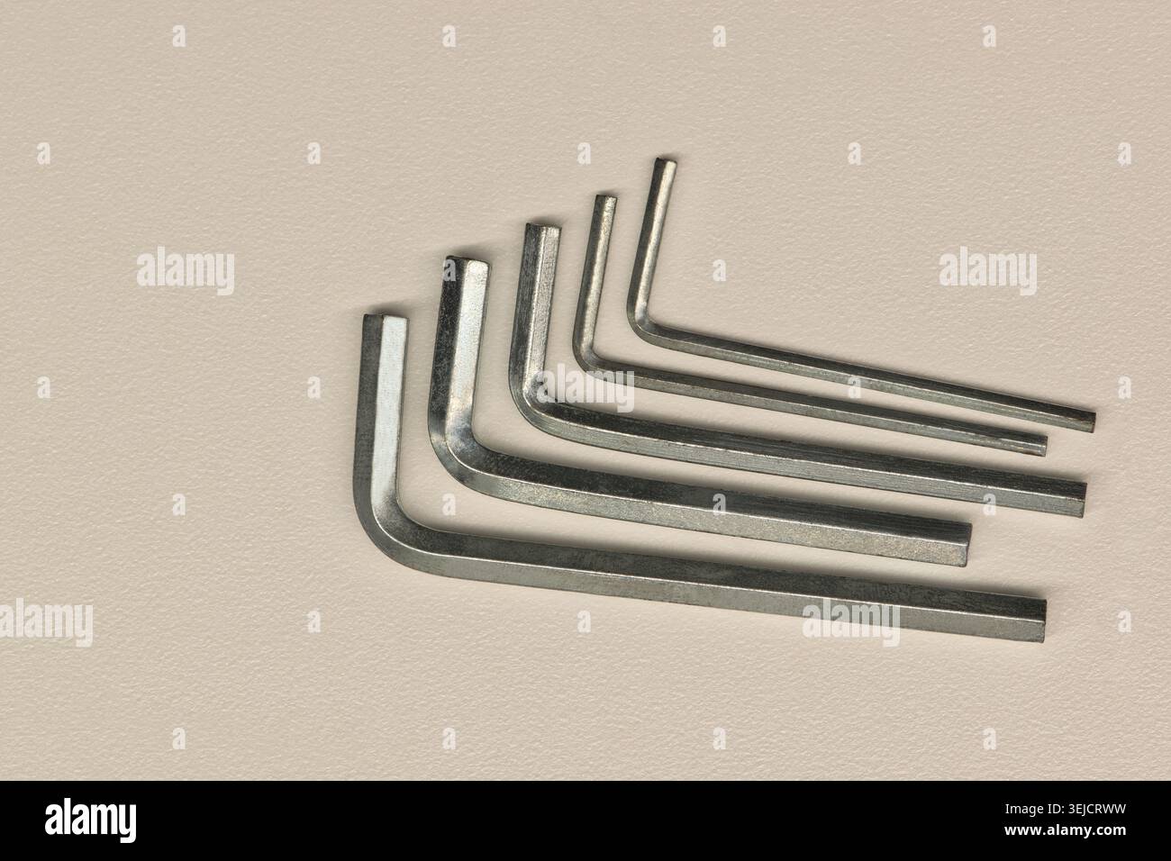 Five assorted allen wrenches flat lay on white background fastening tools. Stock Photo