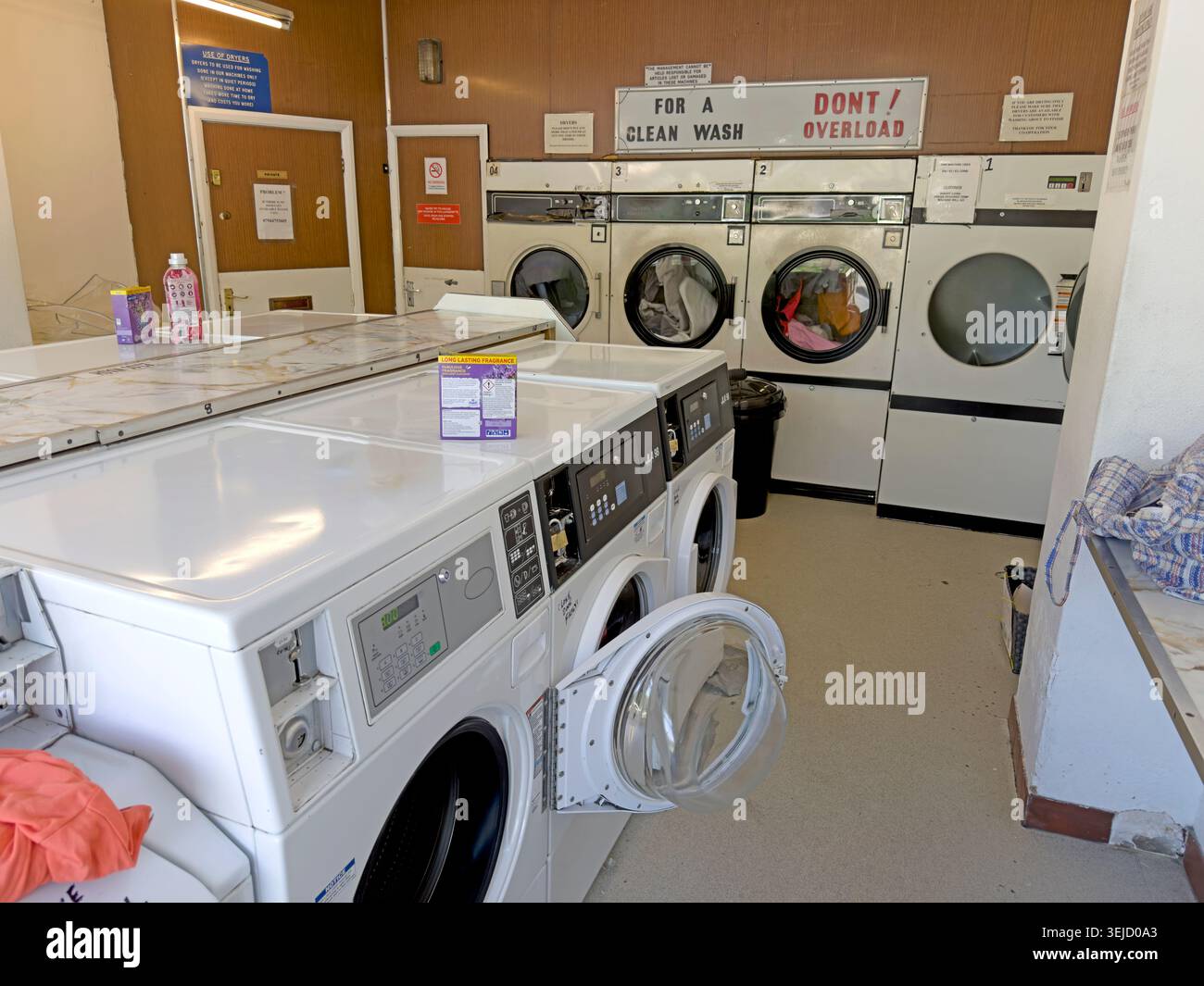 Old-style Latchford, Warrington launderette with coin-operated washers and dryers, a once common British high-street service now much rarer. Stock Photo