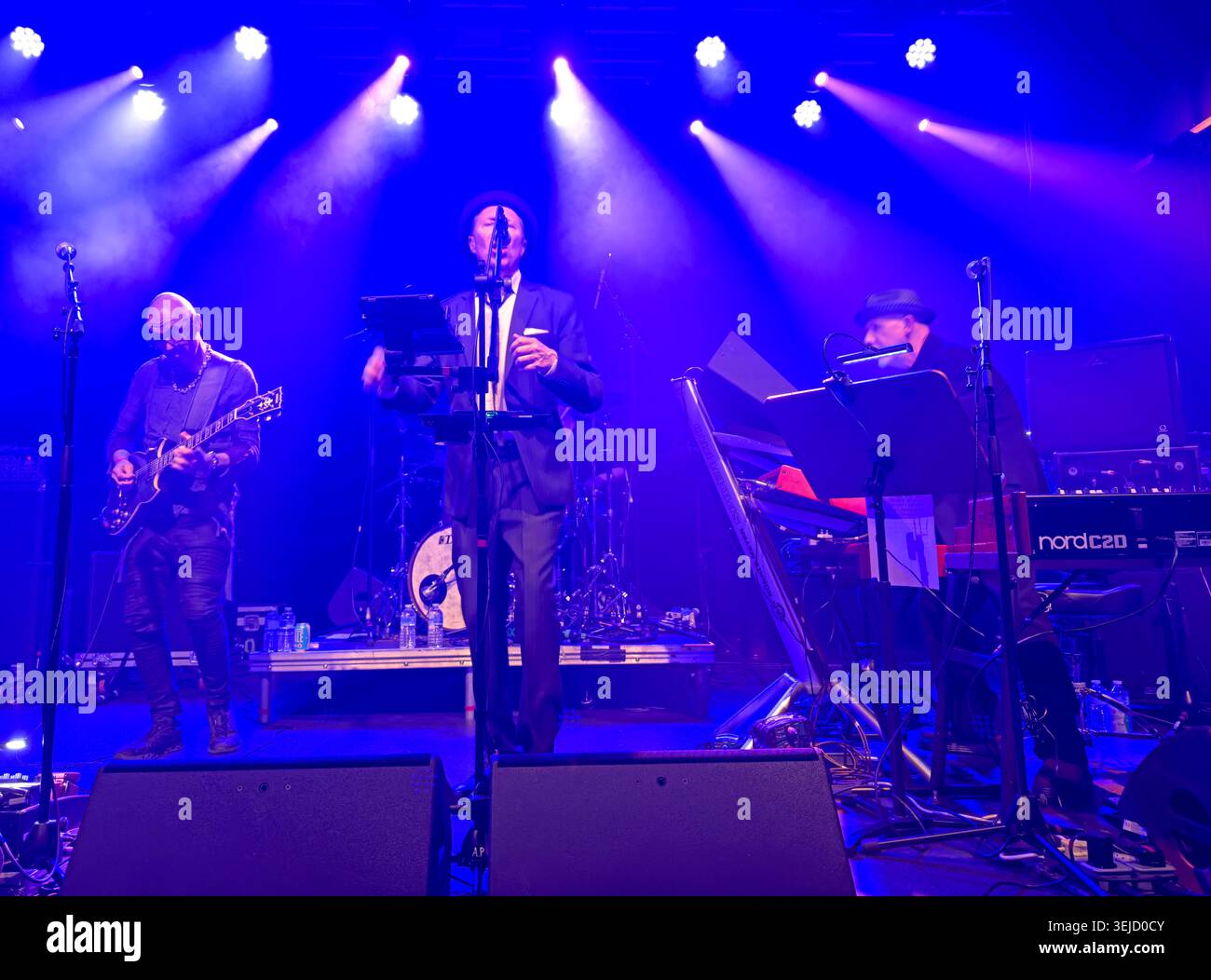 Wide stage shot of Dave Formula, Peter Petersen (Affection Place) and Noko’s Floorboards tour under blue and purple lights at Manchester Academy 2. Stock Photo