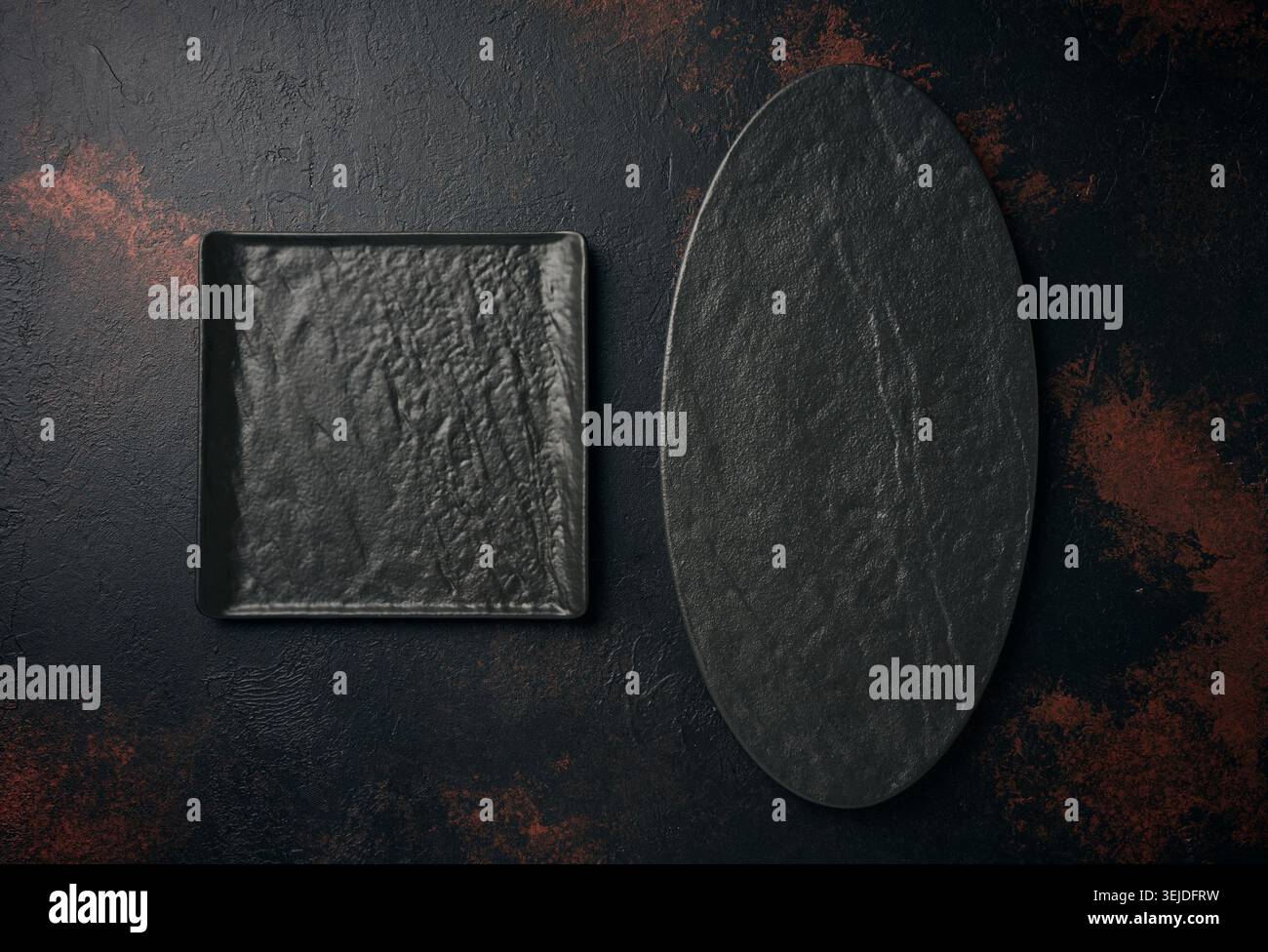 Oval and square stone kitchen board on black background, top view Stock Photo