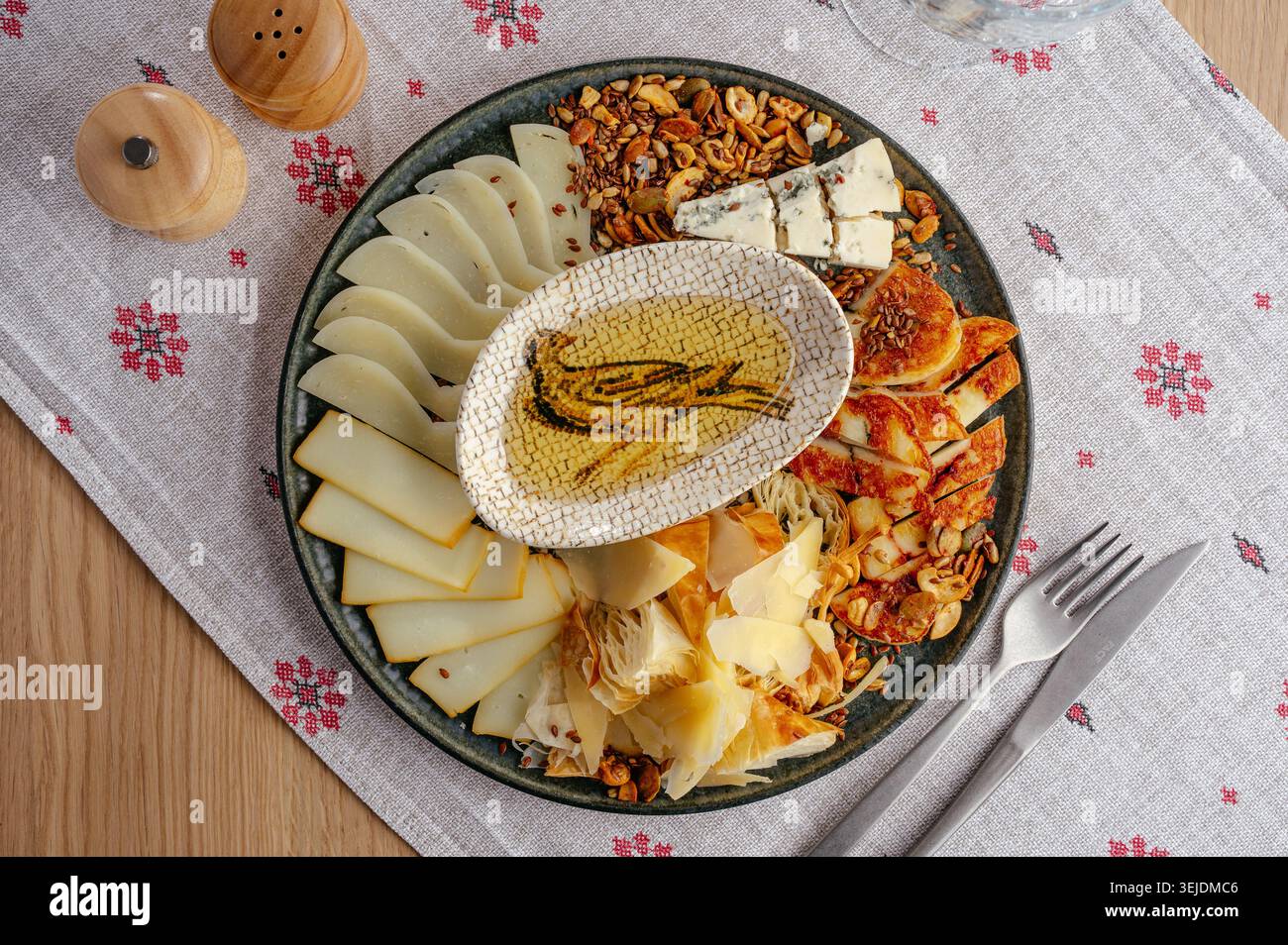 Gourmet cheese platter with assorted nuts and honey Stock Photo