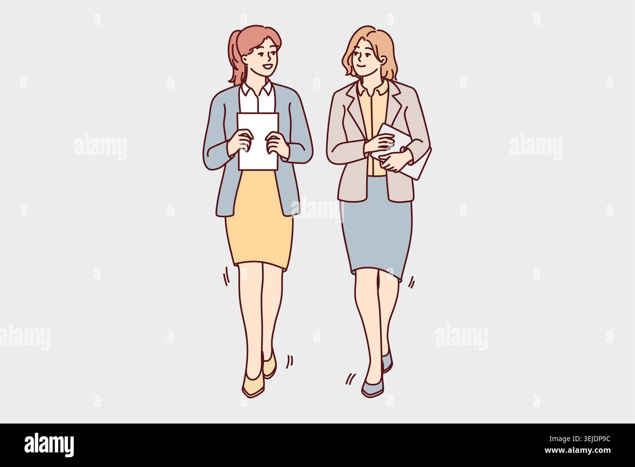 Businesswomen walk talking in office Stock Photo
