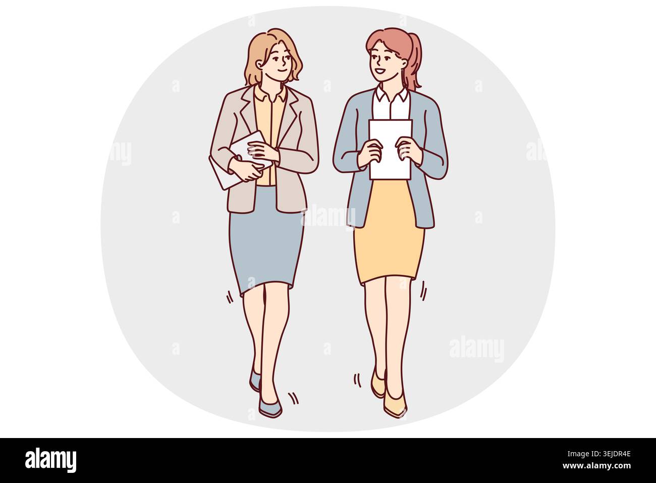 Businesswomen walk talking in office Stock Photo