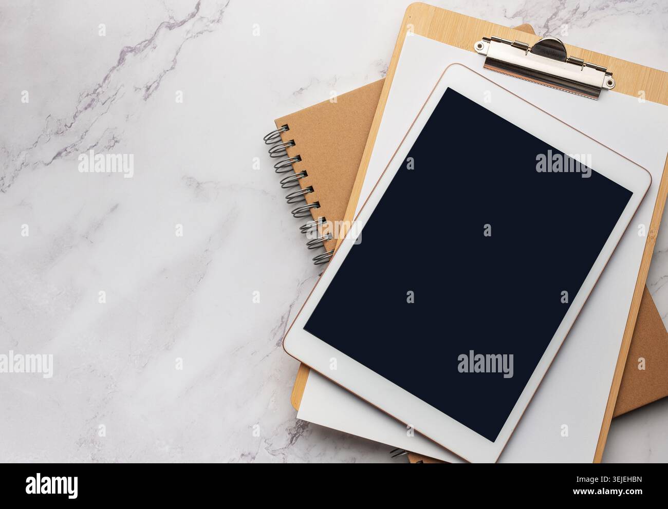 Tablet pc and notebooks on the office desk Stock Photo