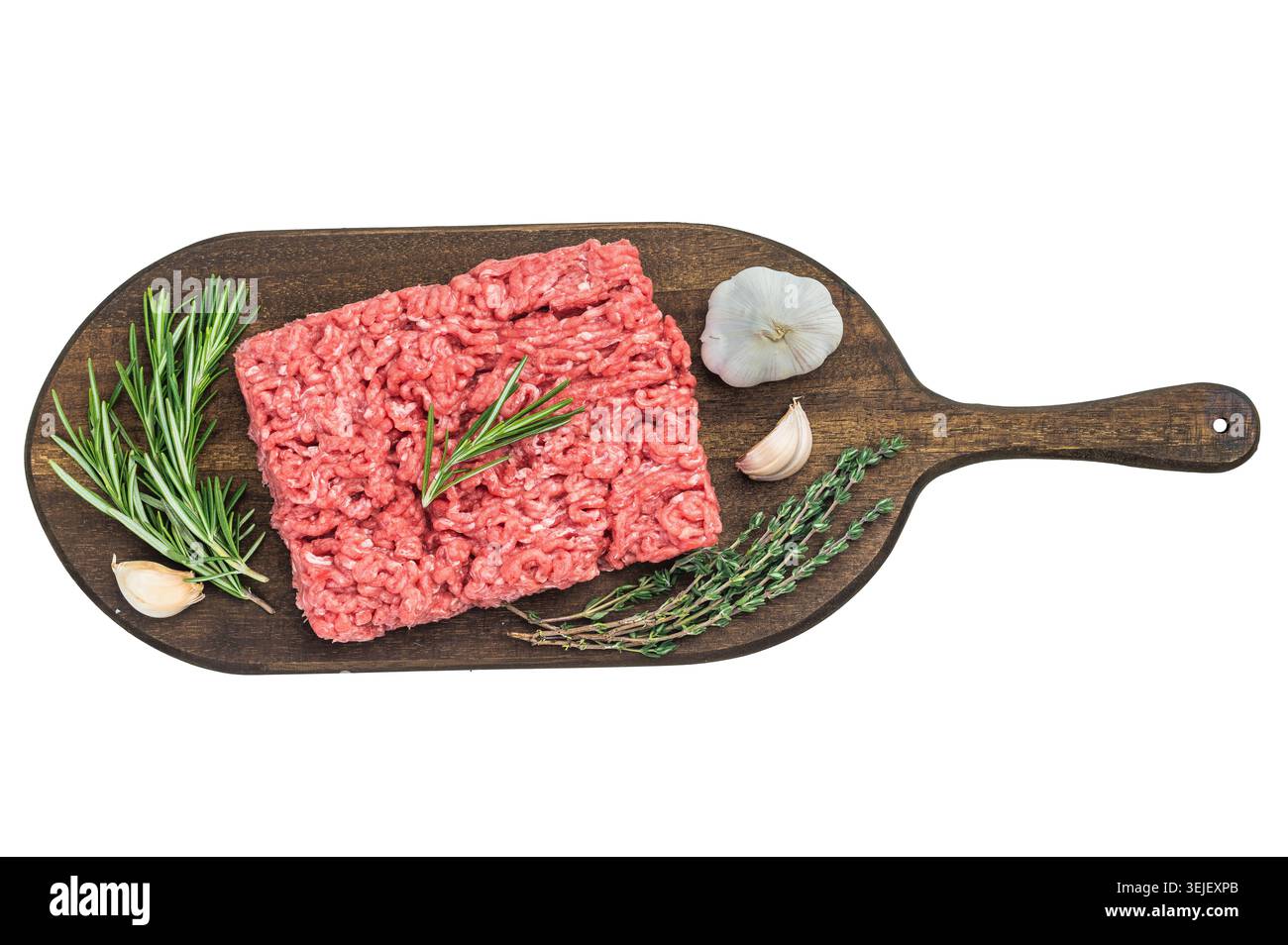 Fresh raw groundmeat with rosemary and thyme on dark wooden board against white background ideal for cooking, butcher and protein themes Stock Photo