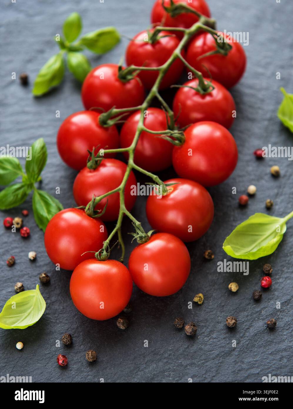 Cherry tomatoes on a black Stock Photo