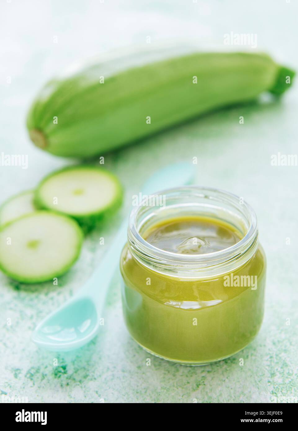 Jar with healthy baby food and zucchini Stock Photo