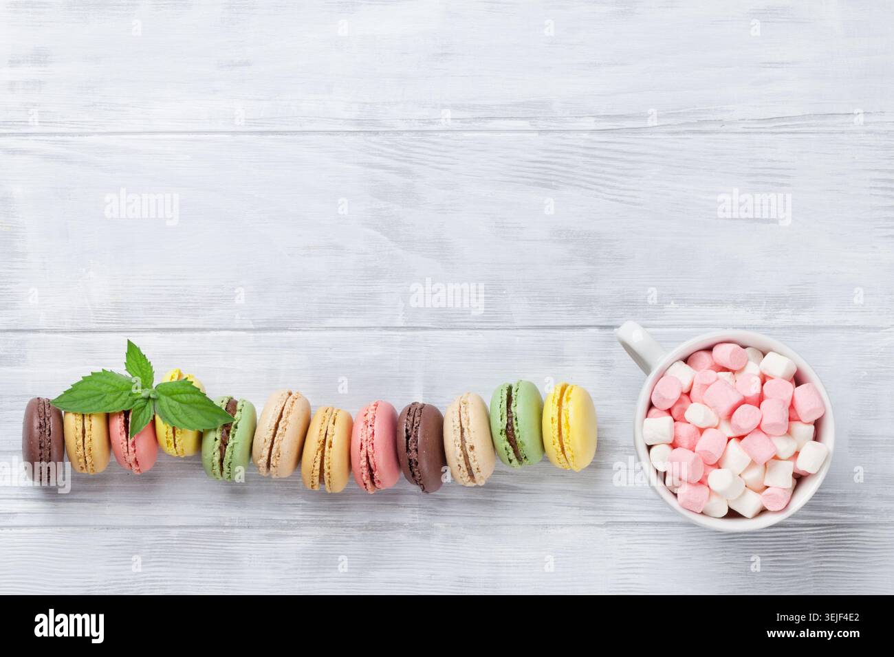 Colorful macaroons on wooden table Stock Photo