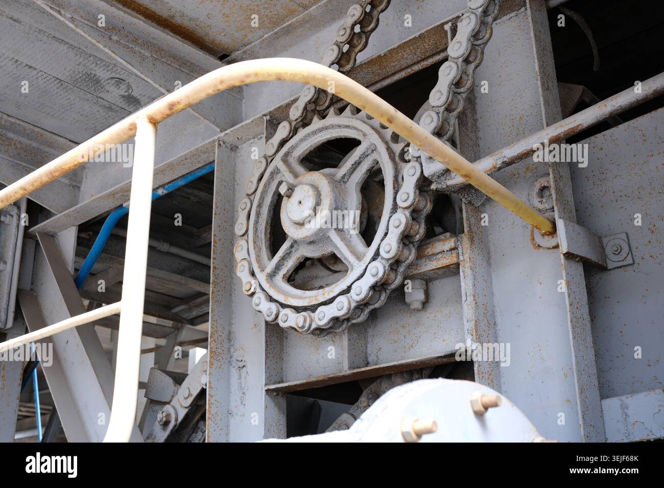 A complex gear mechanism showcases precision engineering in a bustling factory. Stock Photo
