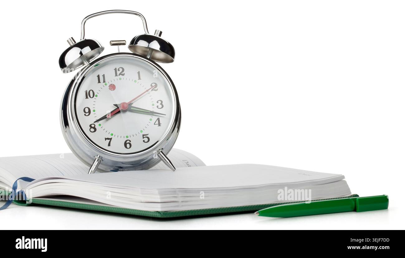 Alarm clock on notepad Stock Photo