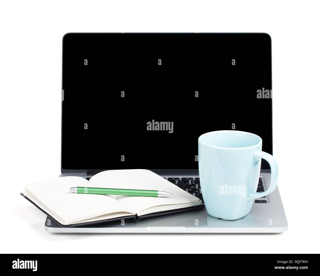 Tea cup and office supplies on laptop Stock Photo