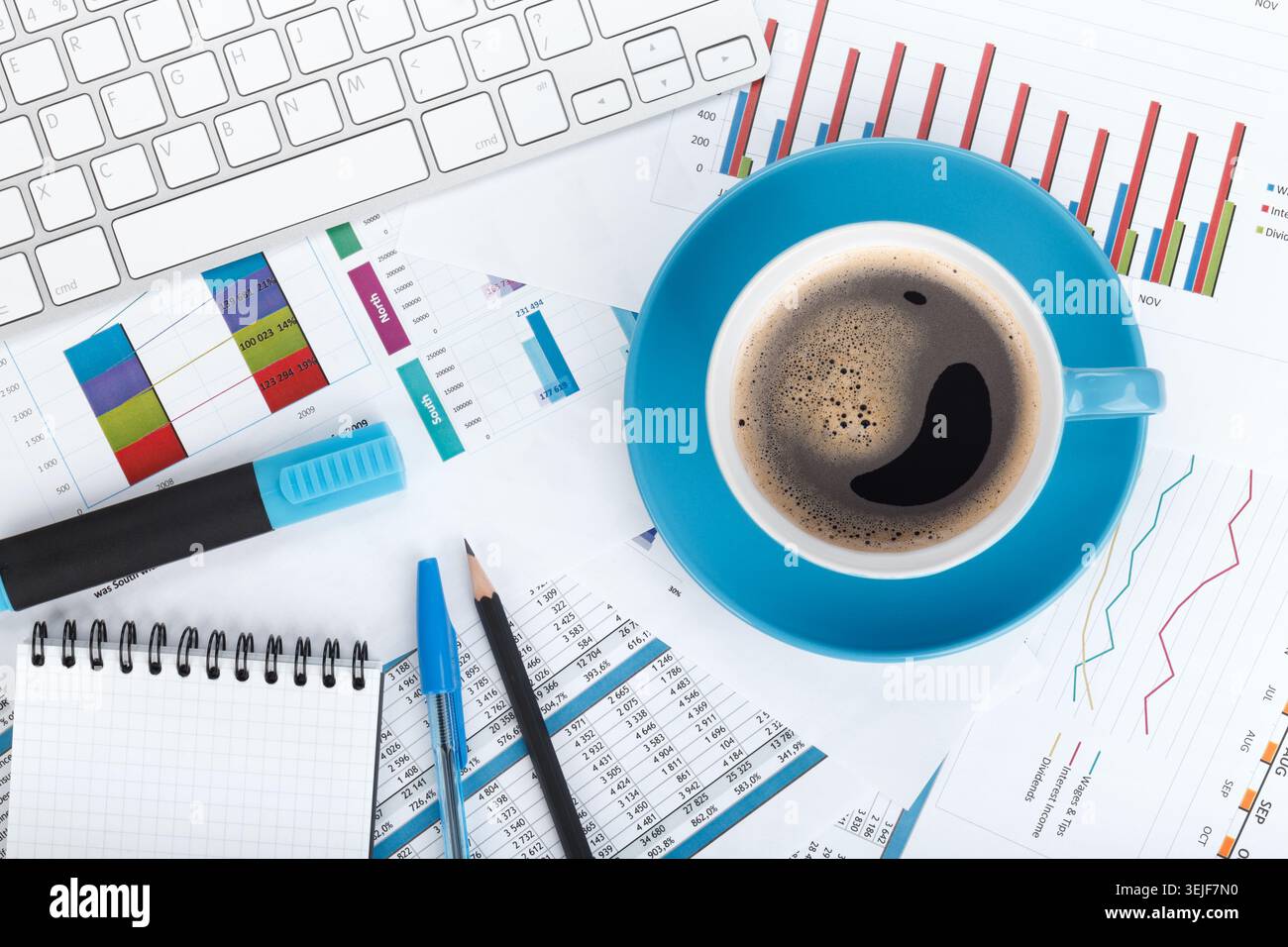 Blue coffee cup on financial papers Stock Photo