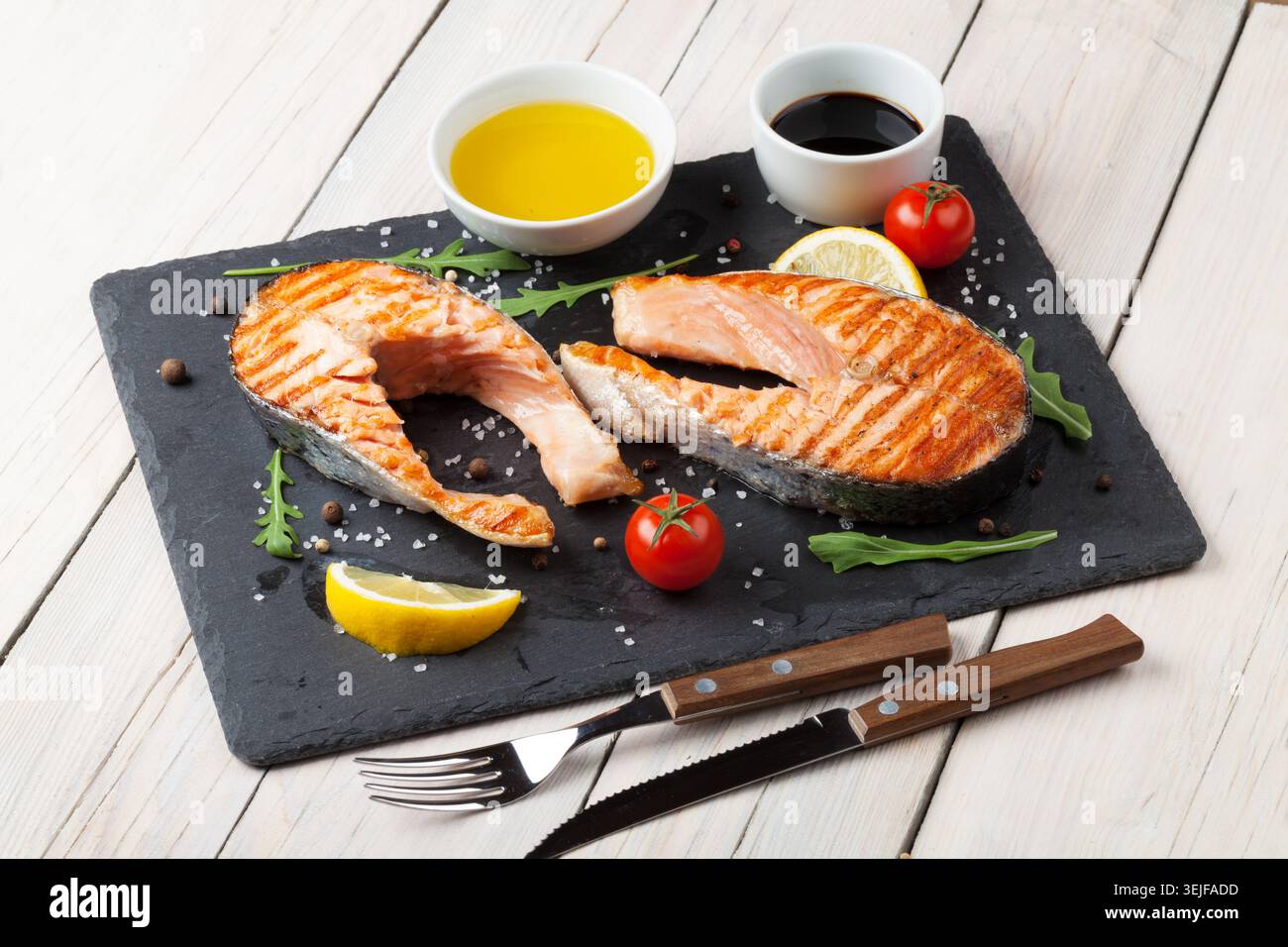 Grilled salmon, salad and condiments Stock Photo