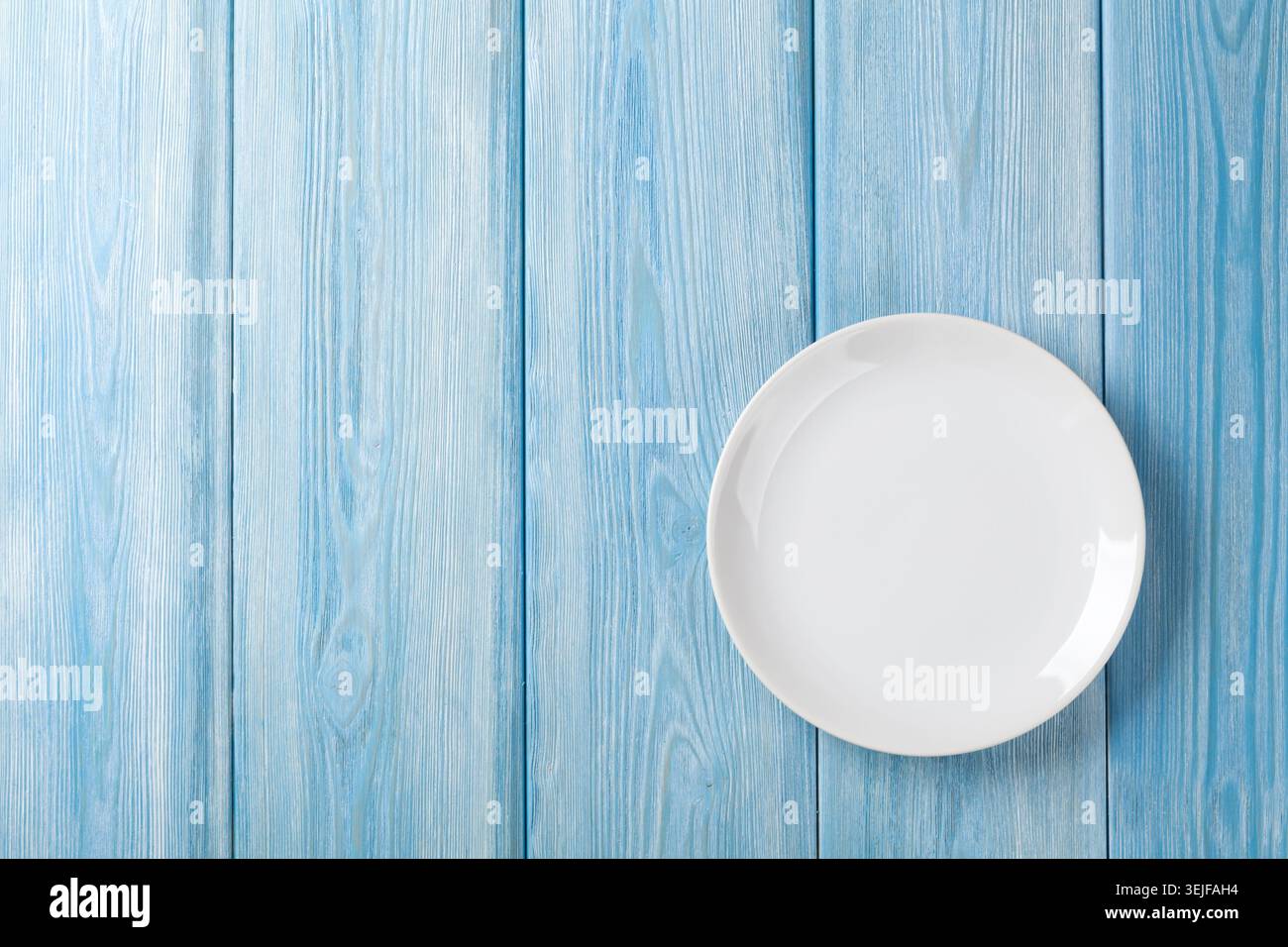 Empty plate on blue wooden background Stock Photo