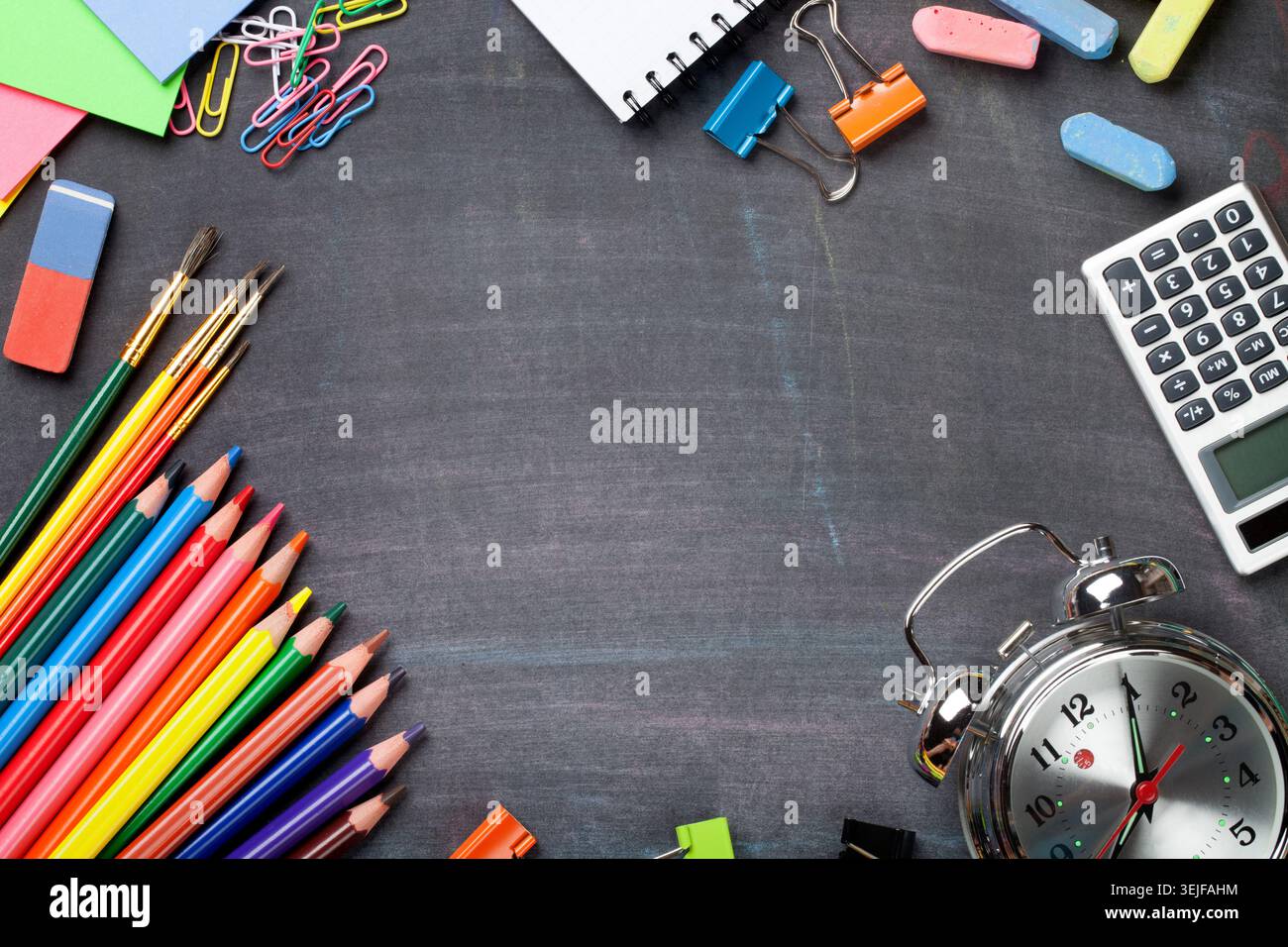 School supplies on blackboard background Stock Photo