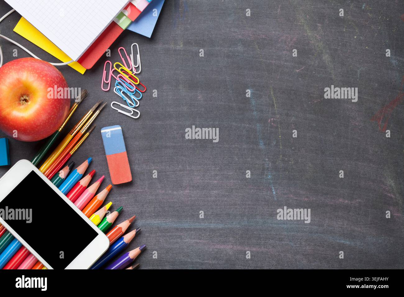 School supplies on blackboard background Stock Photo