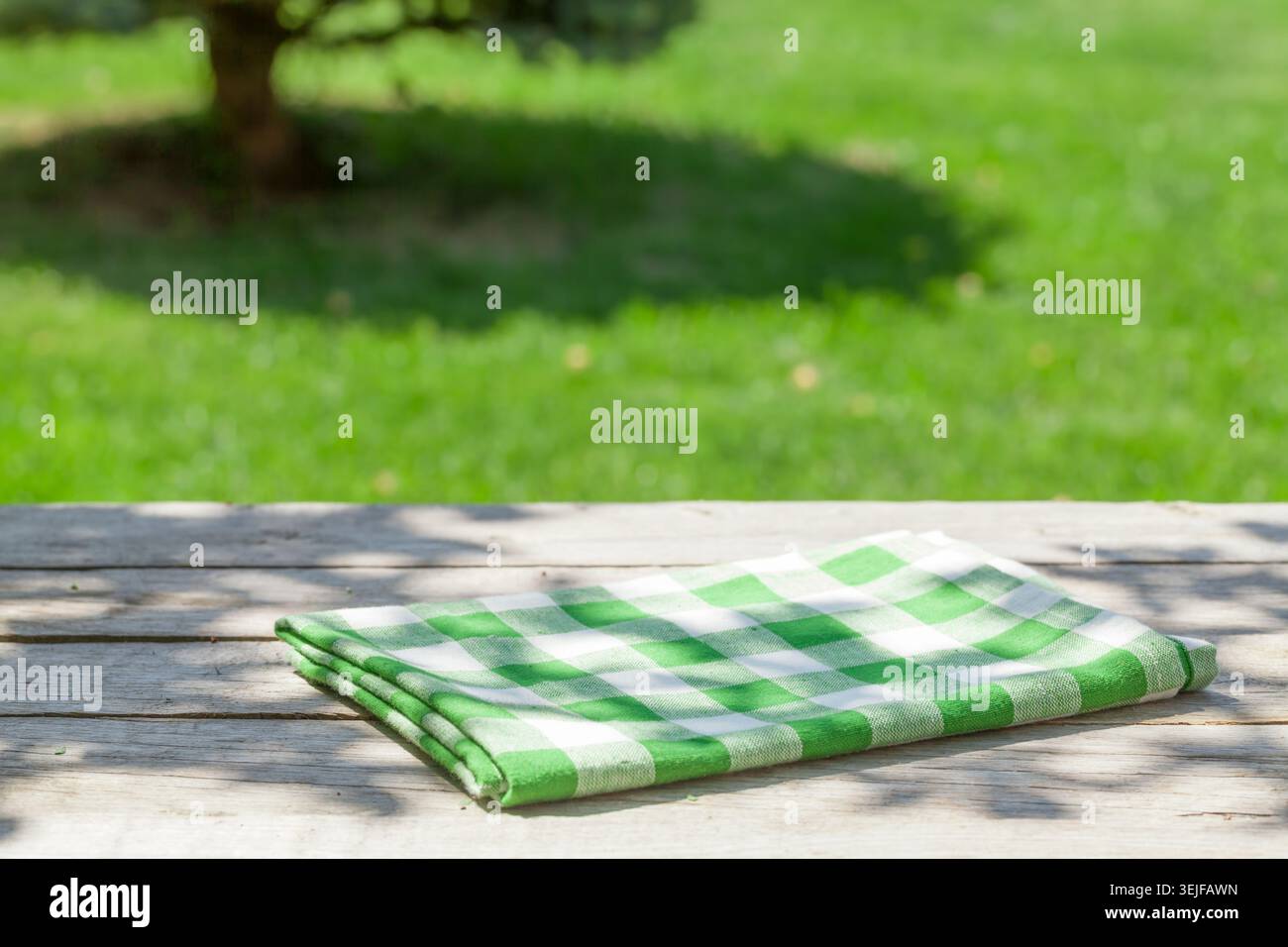 Empty wooden garden table with tablecloth Stock Photo