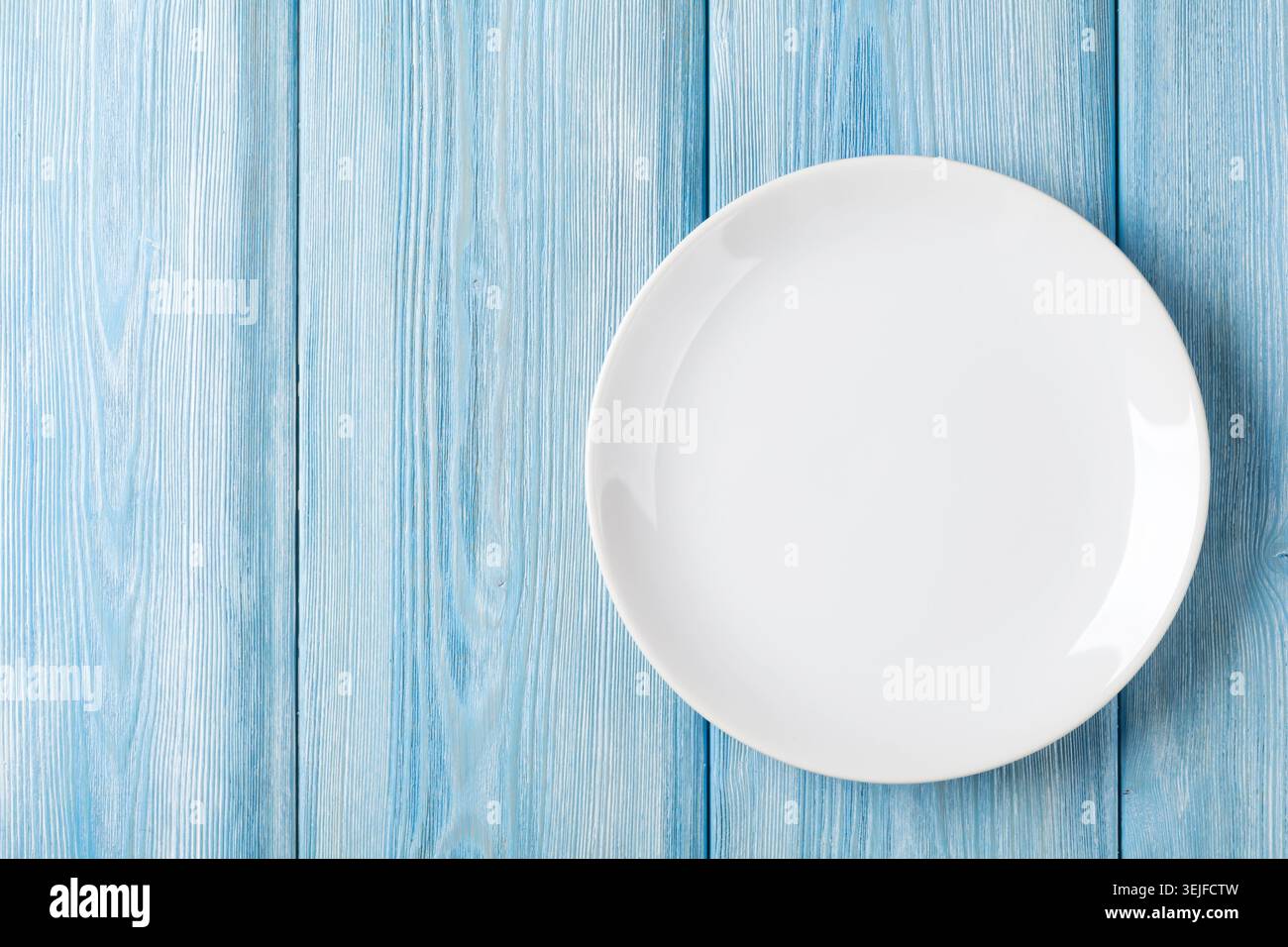 Empty plate on blue wooden background Stock Photo
