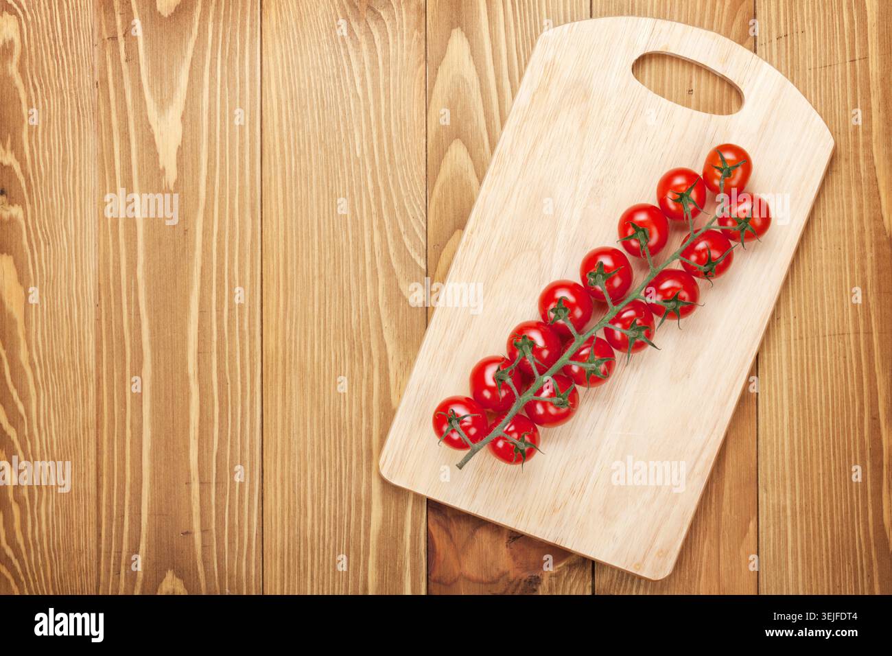 Cherry tomatoes on cutting board Stock Photo