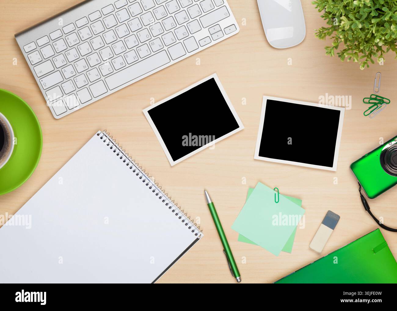 Photo frames on office table with notepad, computer and camera Stock Photo