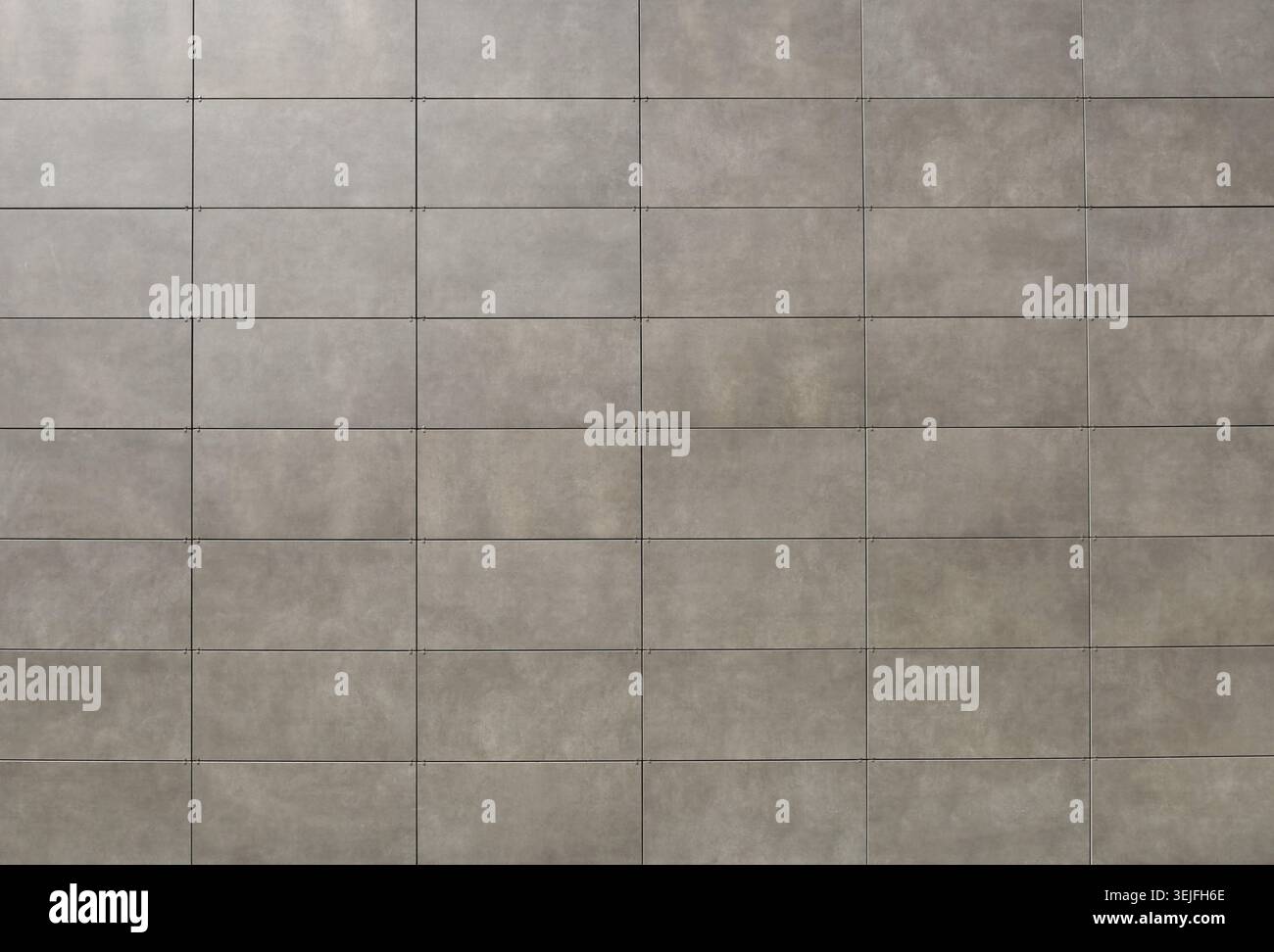 Elegant gray stone tiles for ventilated facade cladding. Background and texture. Stock Photo