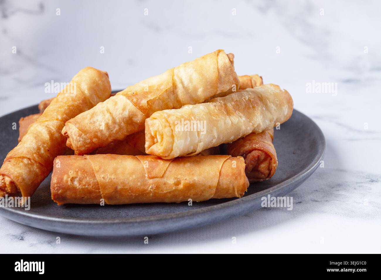 Fried spring rolls with cheese, on a plate, with cream sauce, no people, Stock Photo