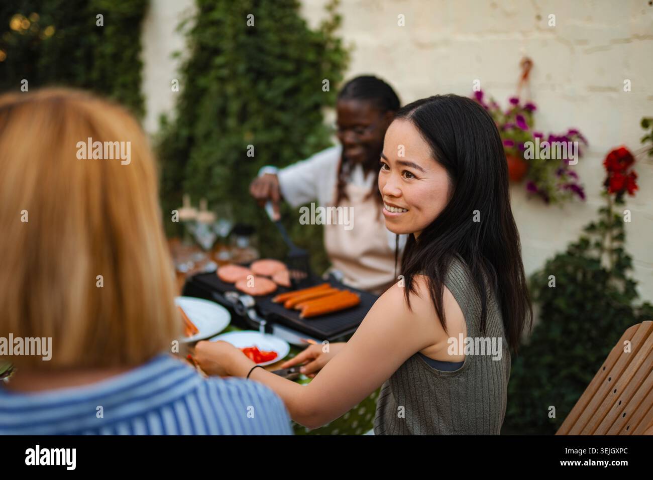 Diverse group of women enjoying outdoor barbecue party Stock Photo