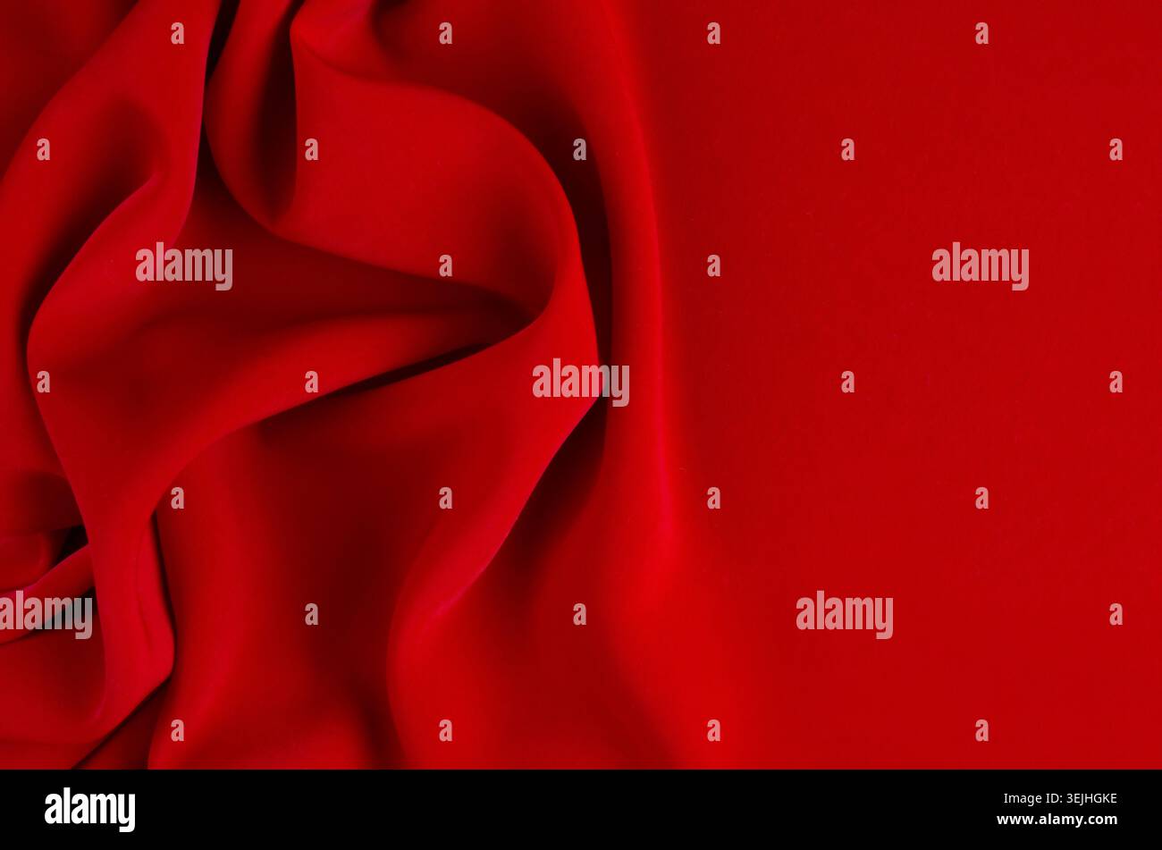 Deep red silk smooth wavy background with copy space. Stock Photo