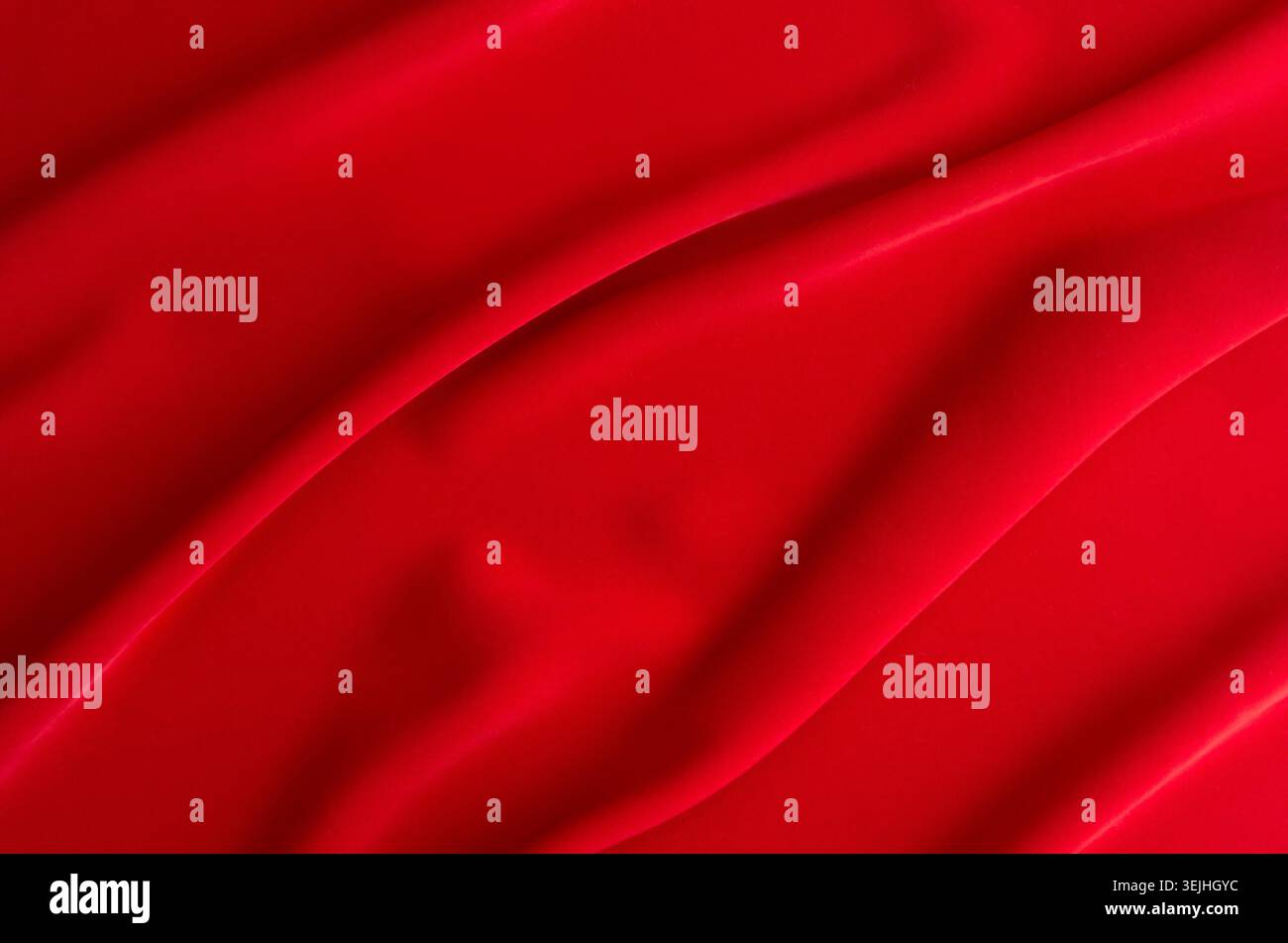 Red silk wavy background. Passion backdrop for Valentines day. Stock Photo