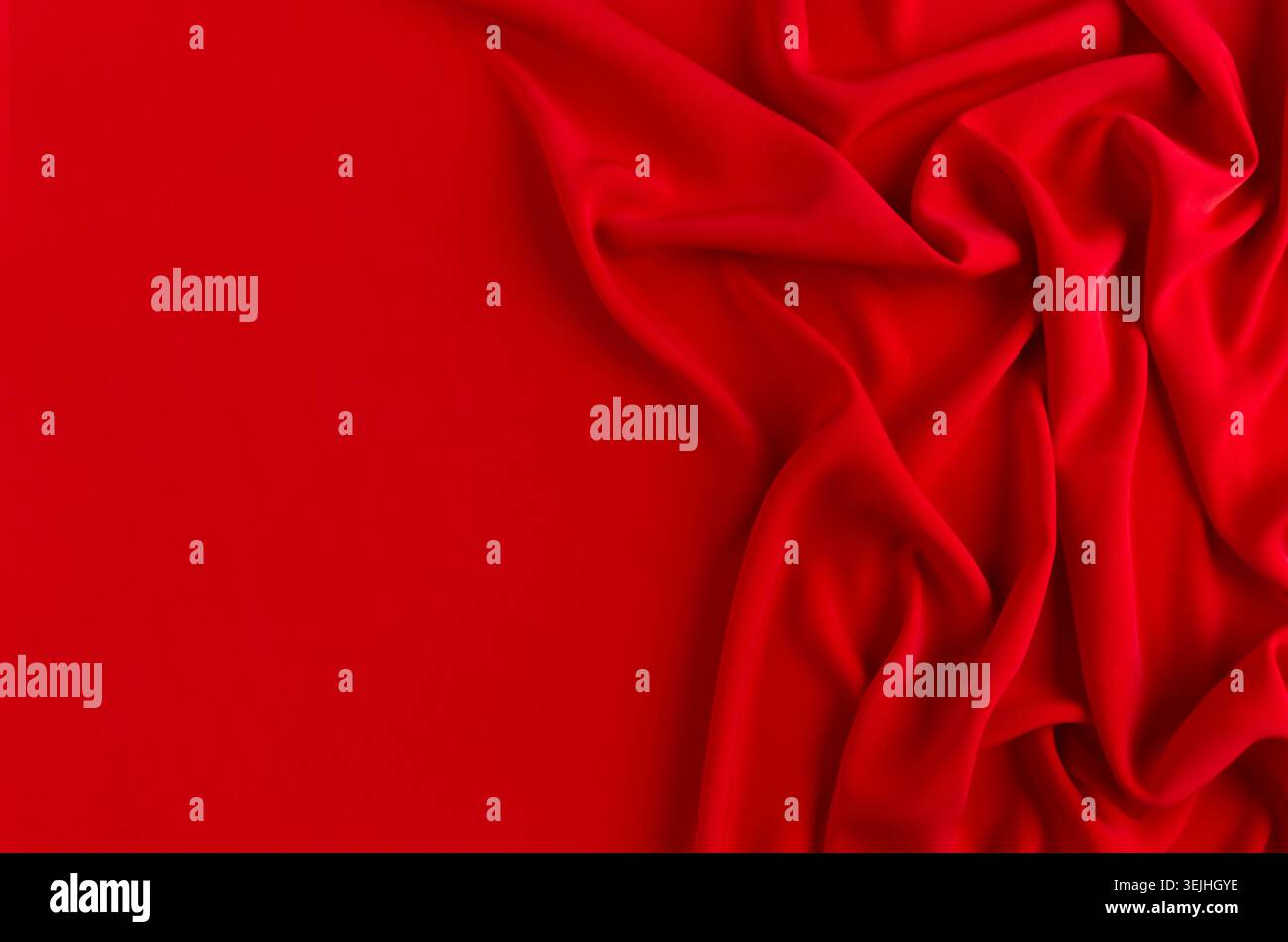 Deep red silk smooth wavy background with copy space. Stock Photo