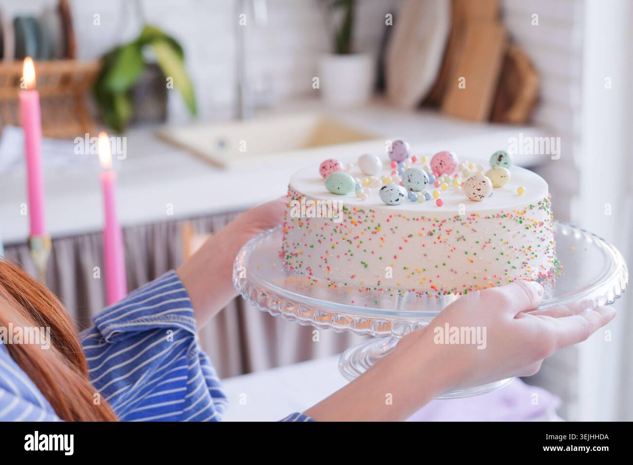 Woman serving table for Easter dinner and holding Easter cake Stock Photo